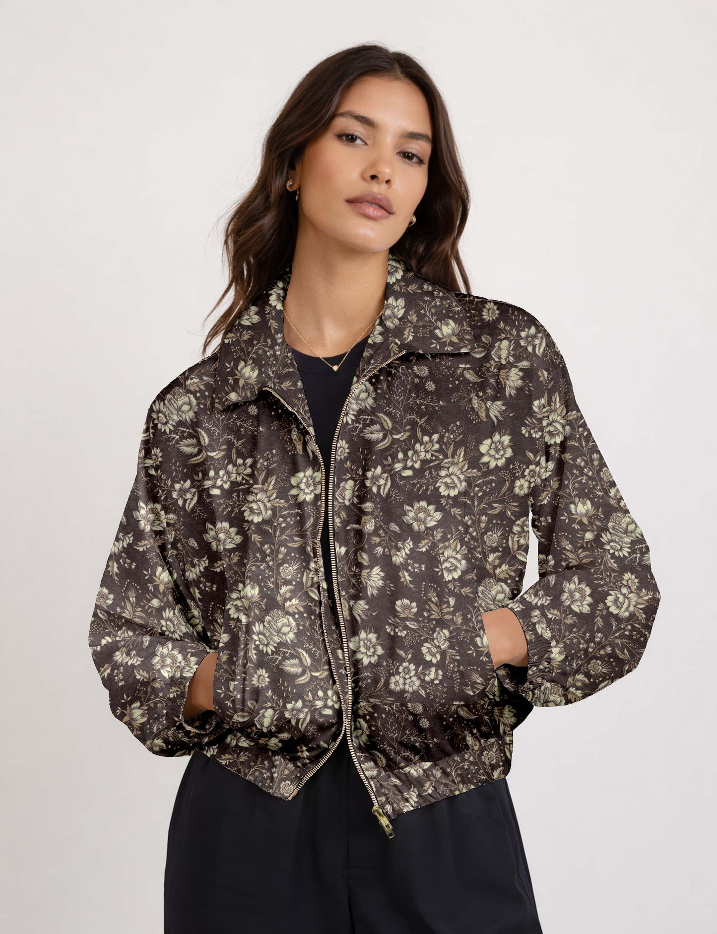 Woman wearing a yellow floral bomber jacket with front zipper, elastic cuffs, and side pockets, shown from front view