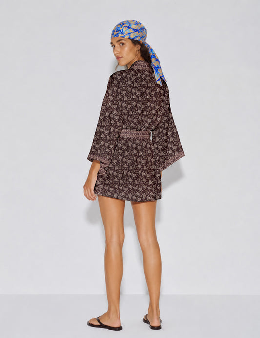 Short kimono robe with wrap front, V-neckline, wide sleeves, waist tie, and concealed skort detail.