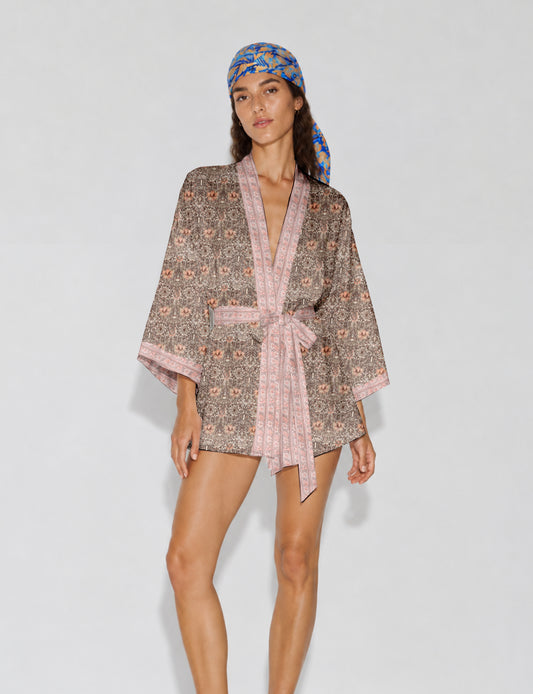 Short kimono robe with wrap front, V-neckline, wide sleeves, waist tie, and concealed skort detail.
