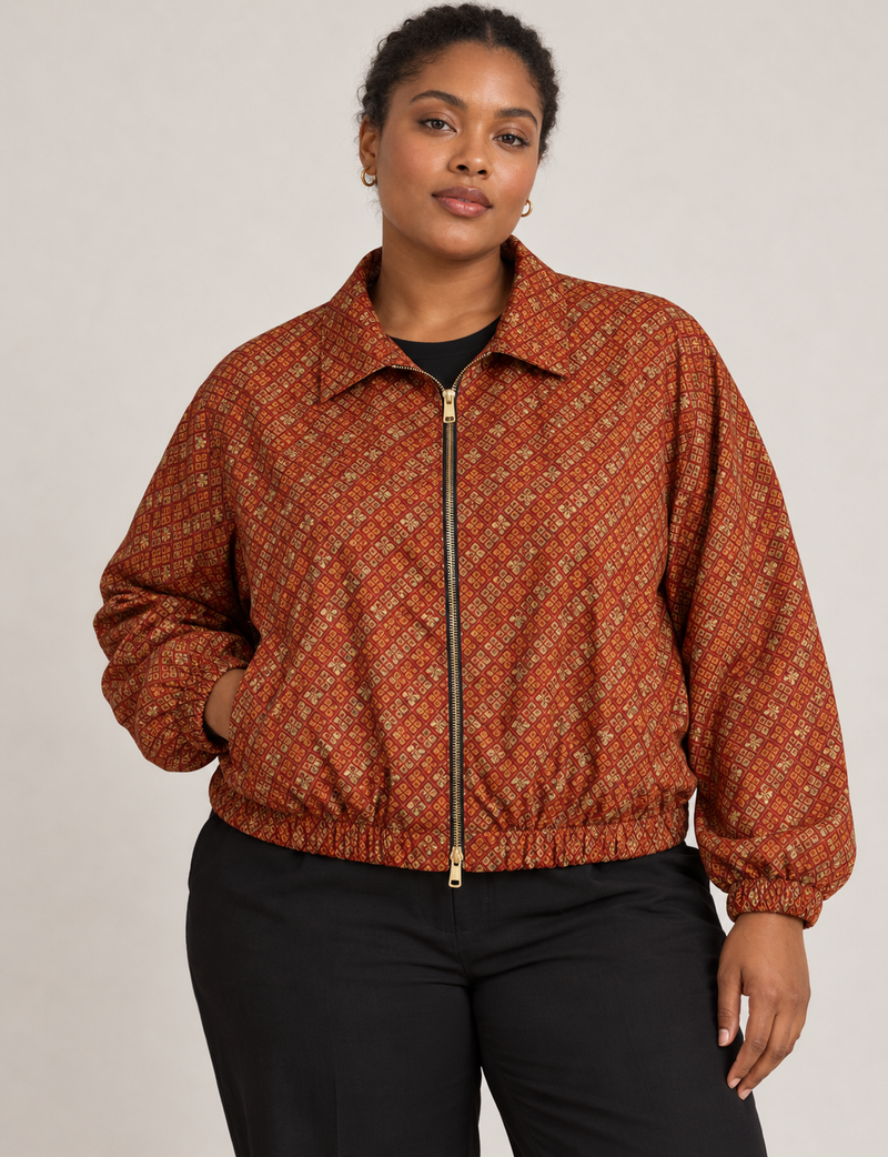 Woman wearing a yellow floral bomber jacket with front zipper, elastic cuffs, and side pockets, shown from front view