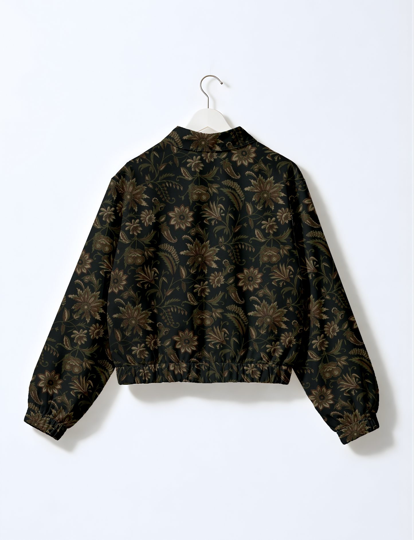 Women's cropped bomber jacket with twin metallic front zippers, welt pockets, elasticated hem and cuffs, and contrast sari print lining.