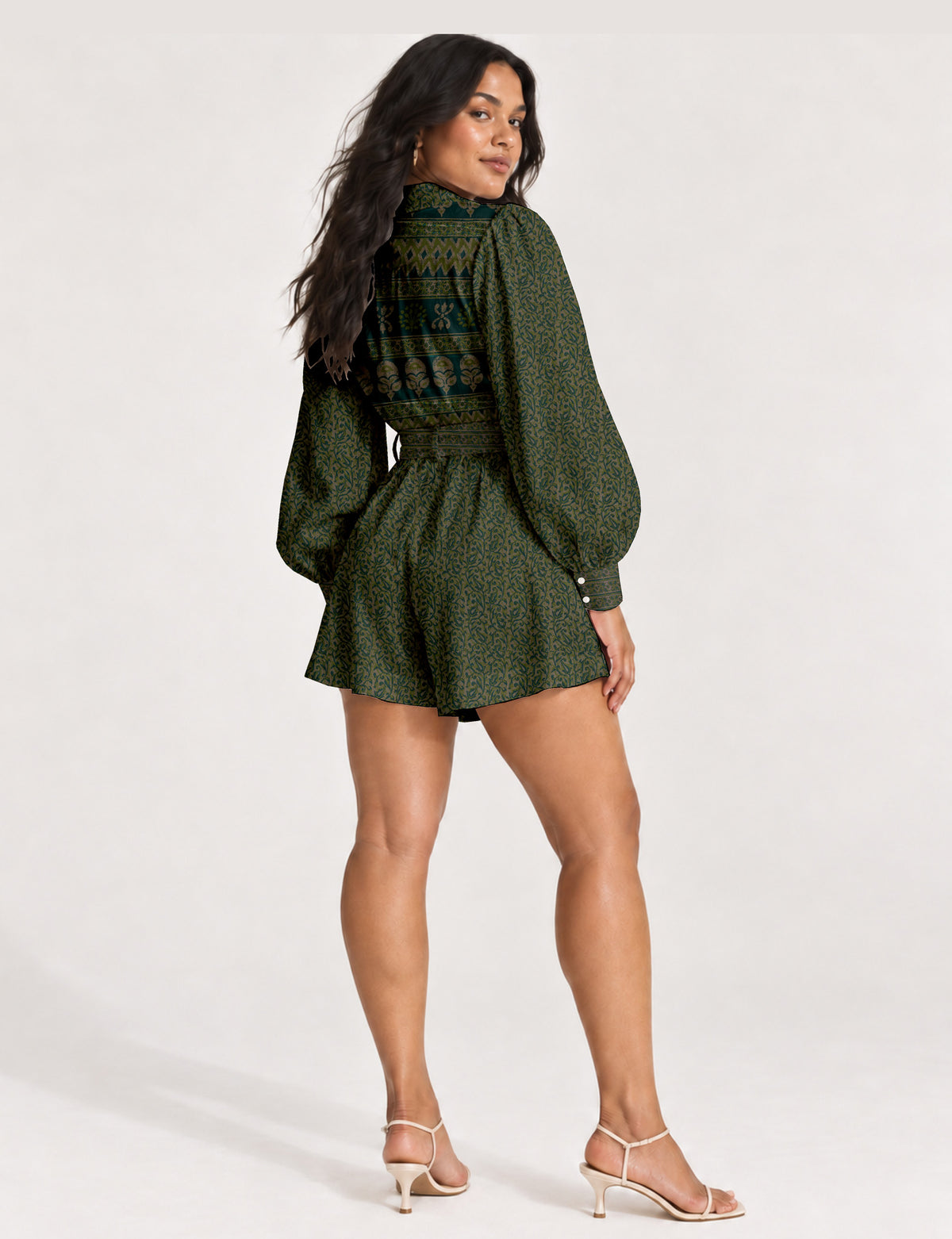 Women’s long sleeve playsuit with wrap-style front, V neckline, notched collar, adjustable waist tie and mid-thigh shorts.