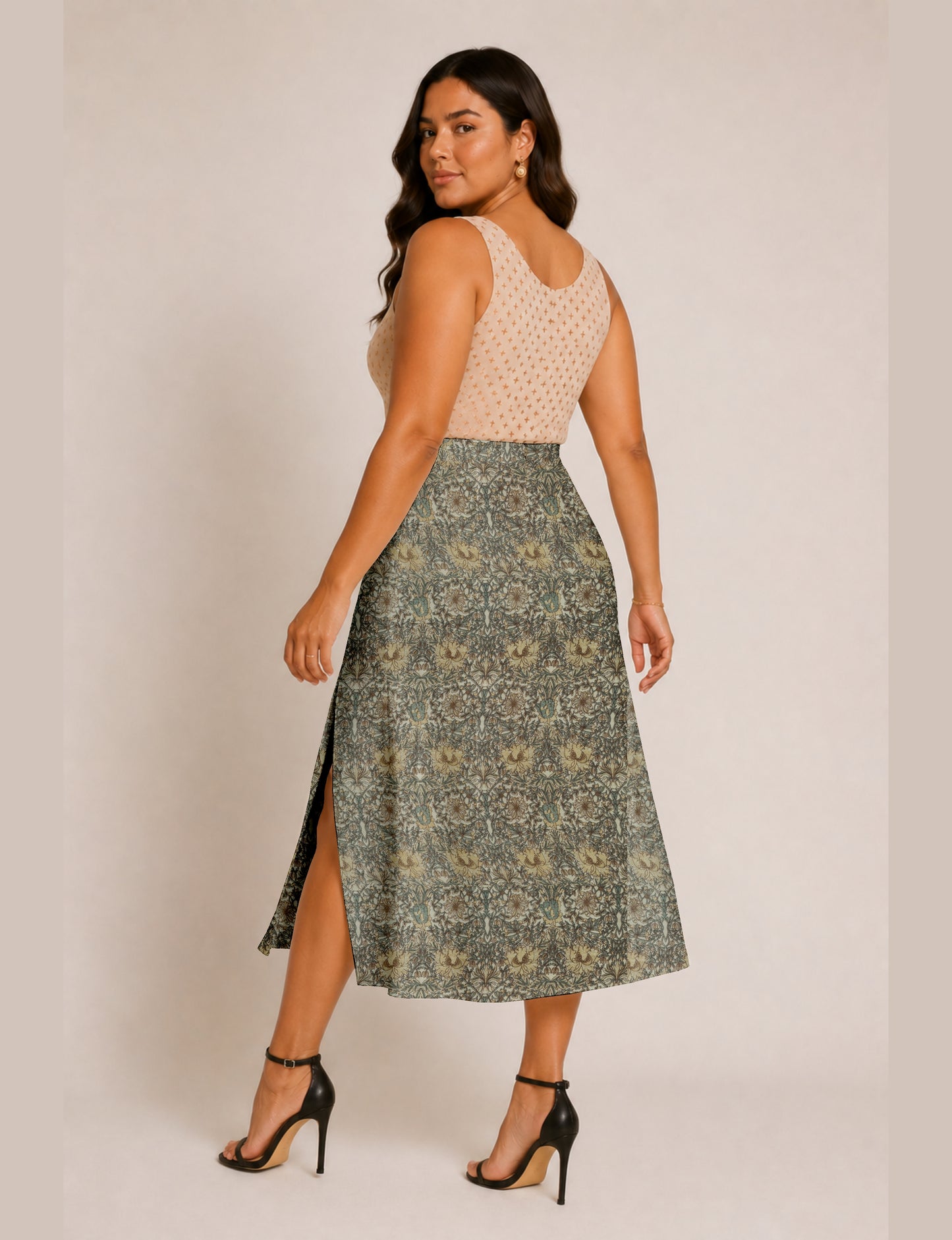 Midi A-line skirt with front slit, fitted waistband, concealed side closure, and below mid-calf length silhouette.