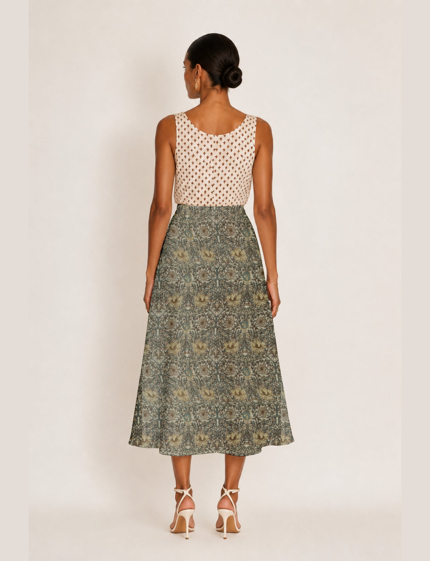 Midi A-line skirt with front slit, fitted waistband, concealed side closure, and below mid-calf length silhouette.