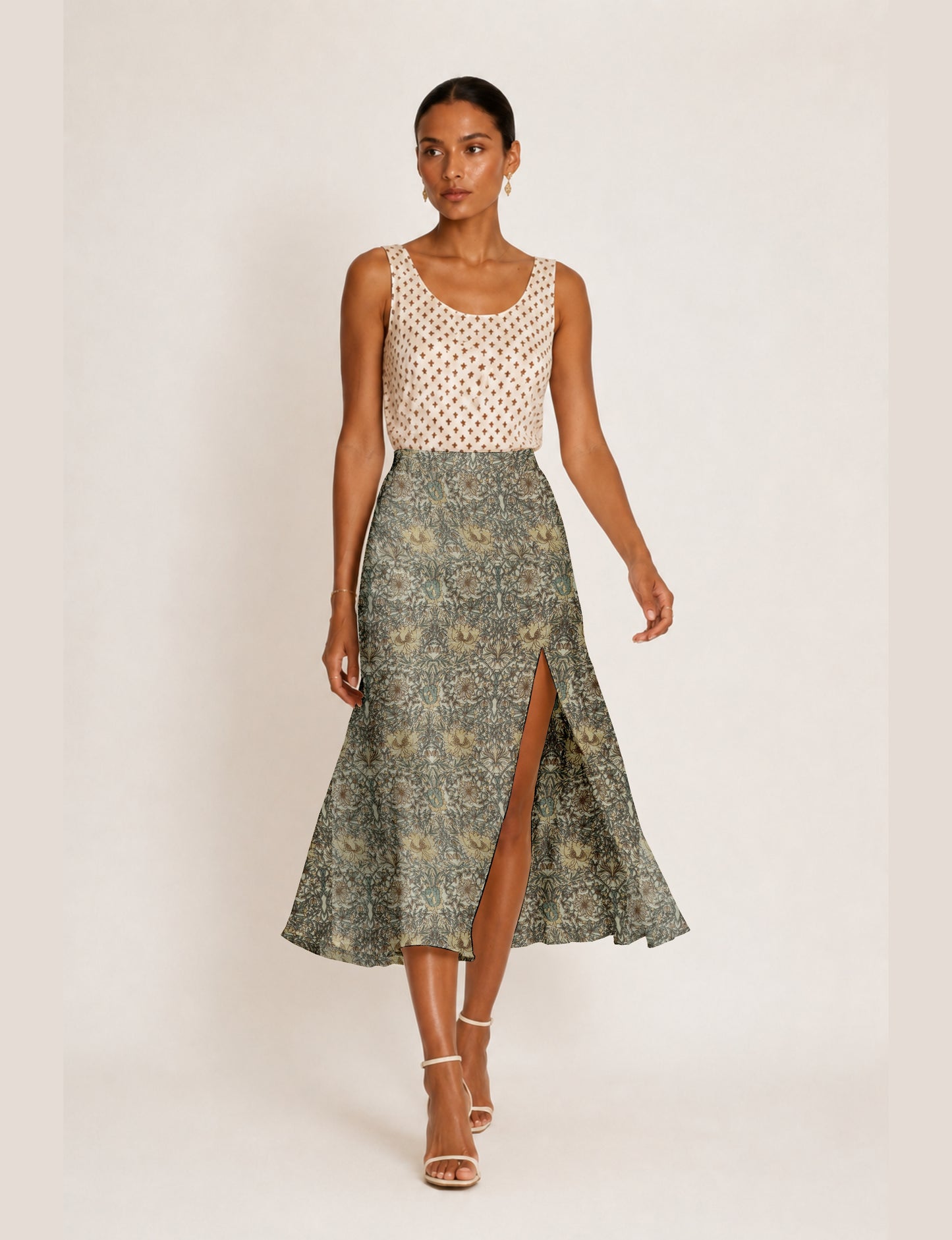 Midi A-line skirt with front slit, fitted waistband, concealed side closure, and below mid-calf length silhouette.