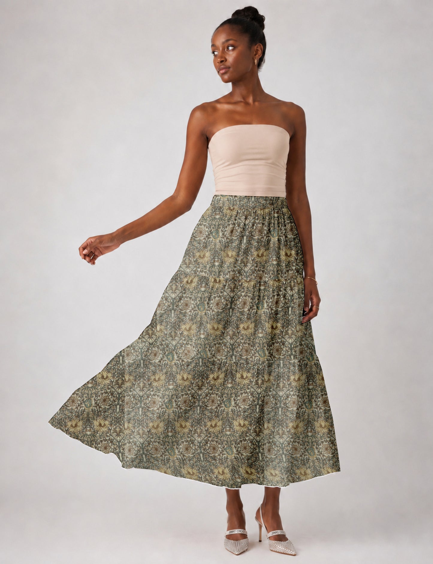 Midi tiered skirt with fitted waistband, soft knife pleats, flared silhouette, side seam pockets, and ankle-length hem
