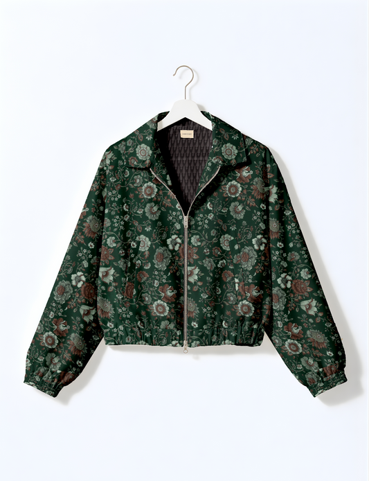 Green floral bomber jacket with front zipper, elastic cuffs and waistband, hanging on white hanger, front view