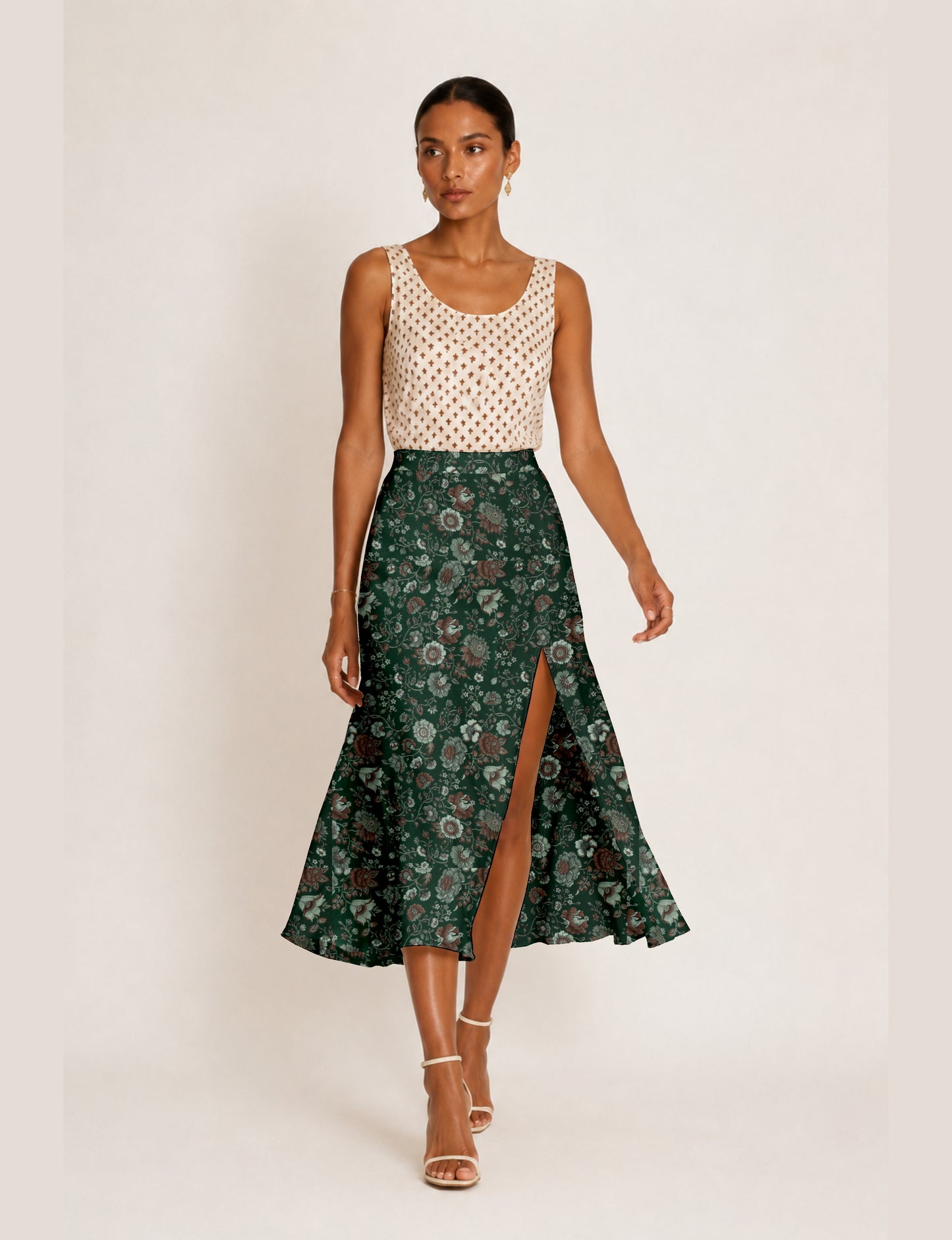 Midi A-line skirt with front slit, fitted waistband, concealed side closure, and below mid-calf length silhouette.