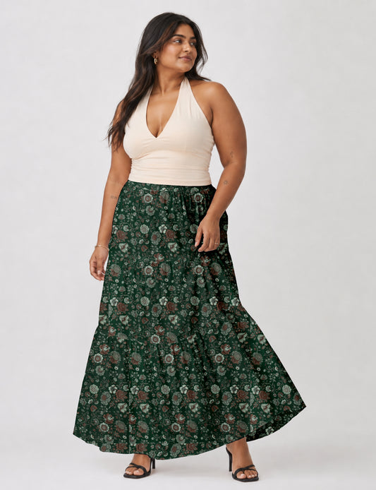 Midi tiered skirt with fitted waistband, soft knife pleats, flared silhouette, side seam pockets, and ankle-length hem