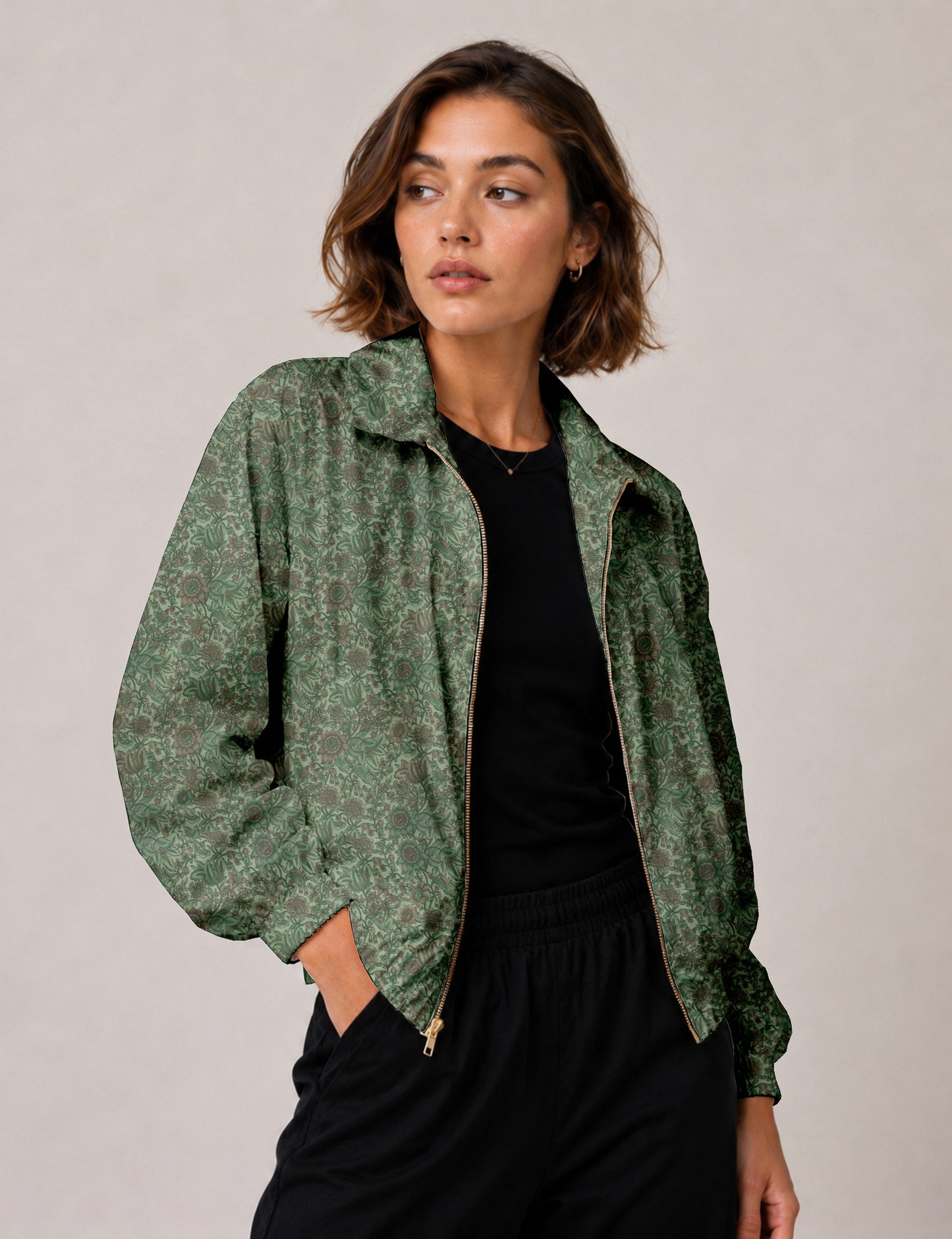 Woman wearing a yellow floral bomber jacket with front zipper, elastic cuffs, and side pockets, shown from front view