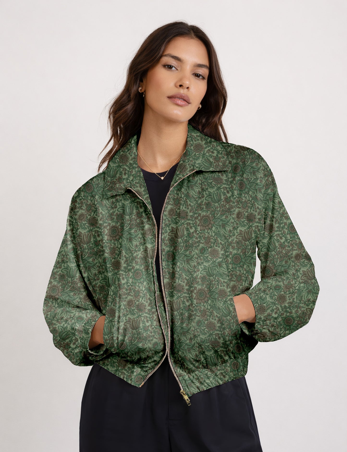 Woman wearing a yellow floral bomber jacket with front zipper, elastic cuffs, and side pockets, shown from front view