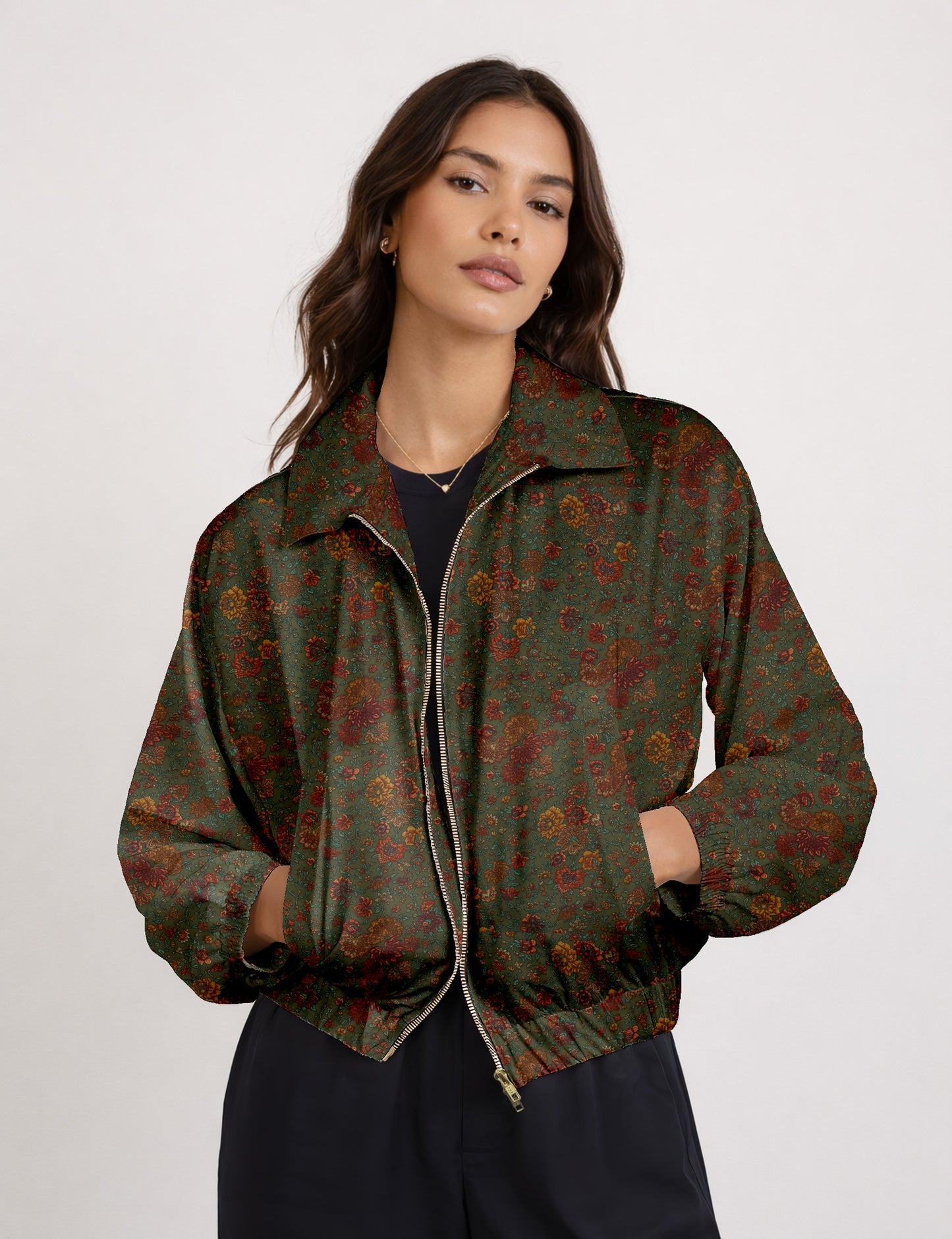 Woman wearing a yellow floral bomber jacket with front zipper, elastic cuffs, and side pockets, shown from front view