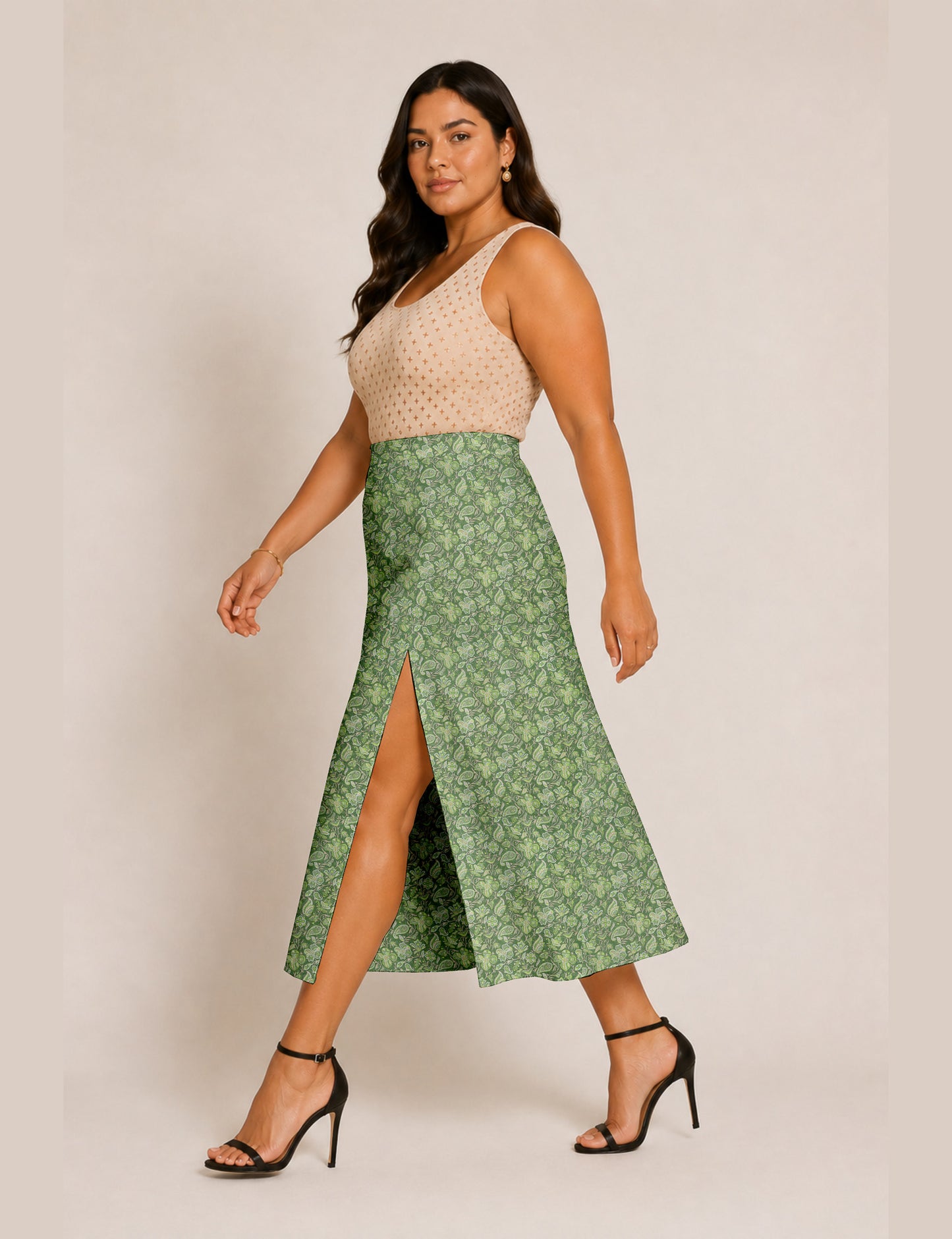 Woman wearing a yellow and black micro patterned A-line skirt with front slit, paired with beige sleeveless top and black
