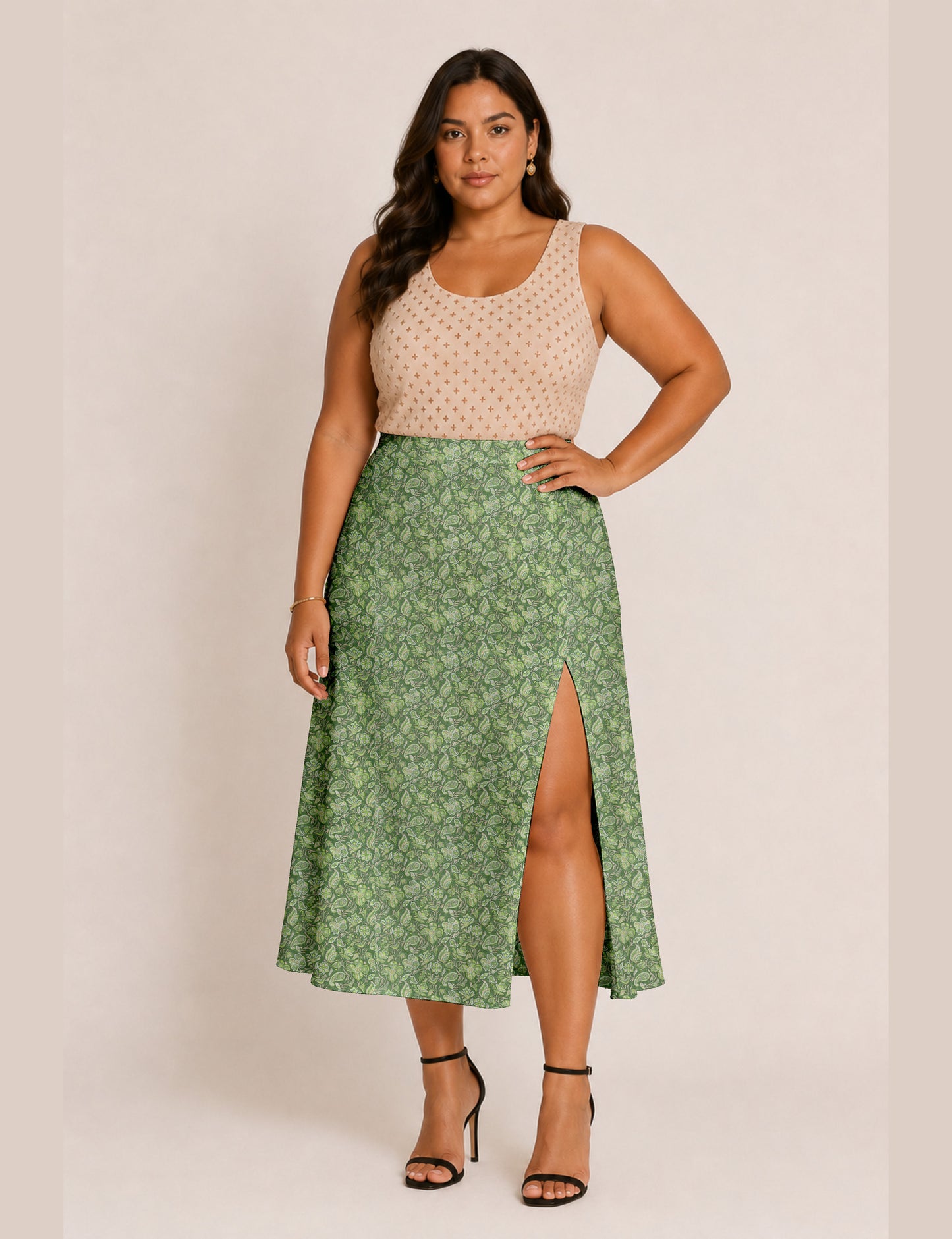 Woman wearing a yellow and black micro patterned A-line skirt with front slit, paired with beige sleeveless top and black