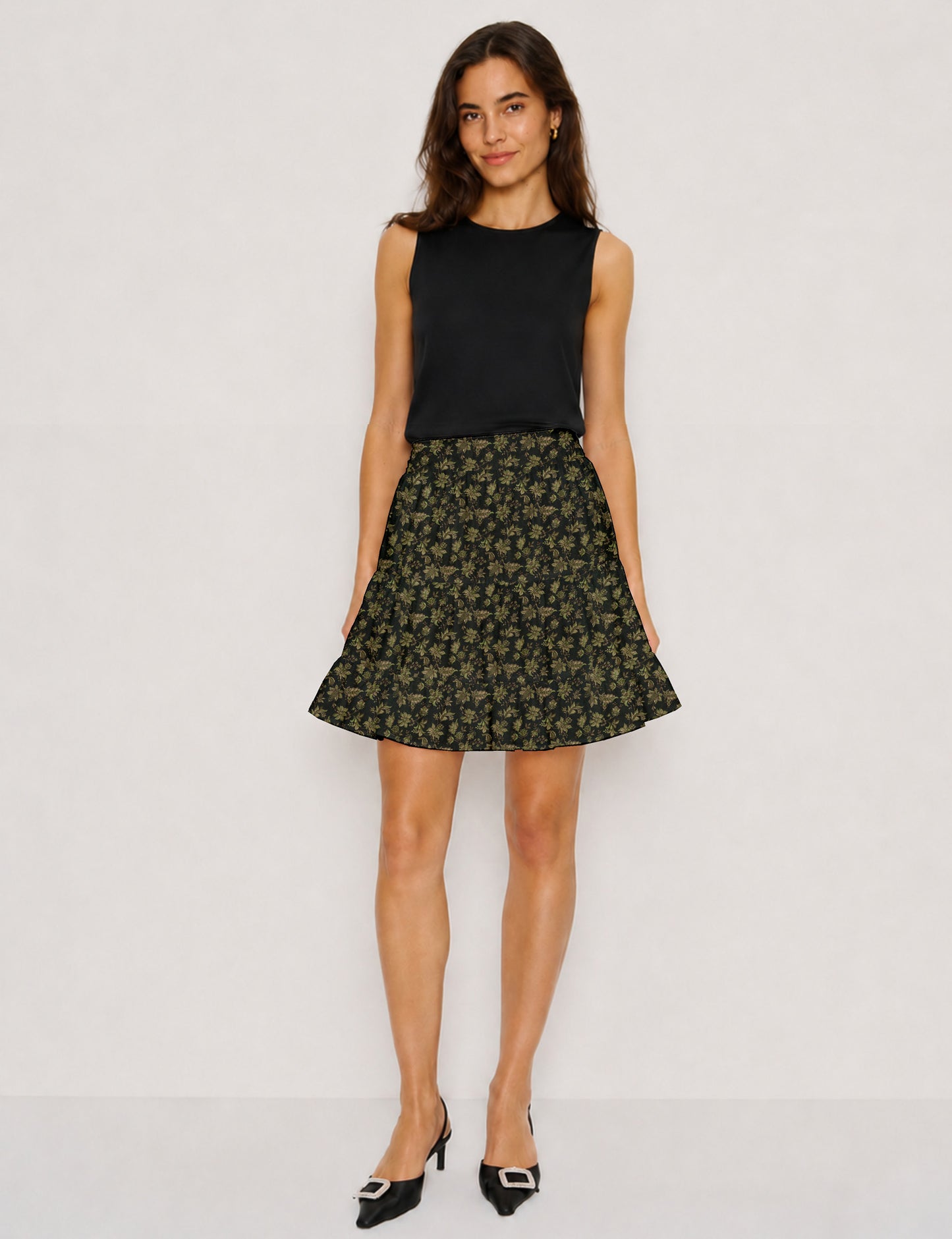 Short tiered skirt with a fitted waistband, knife pleats, softly flared silhouette, side seam pockets, and above-the-knee length.