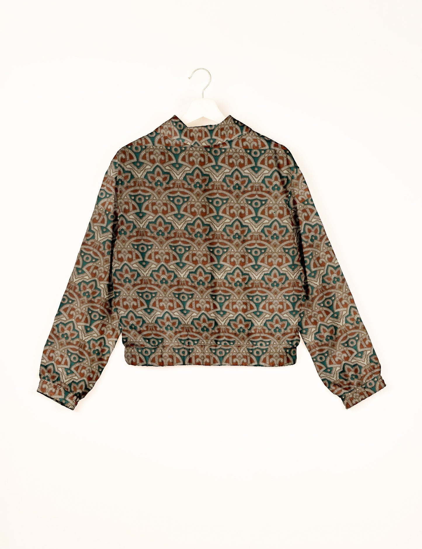 Green bomber jacket with Indian ethnic floral and geometric pattern, long sleeves, elastic cuffs, and back view on hanger