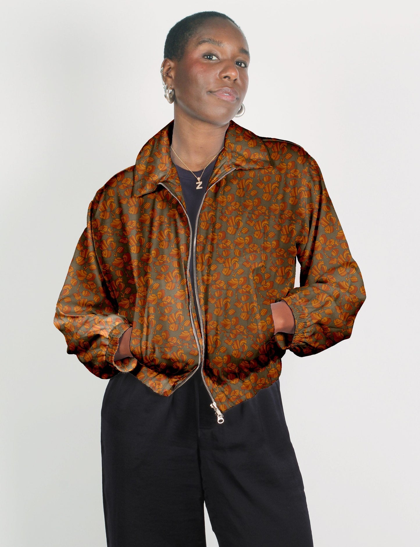 Upcycled Bomber Jacket made from recycled sari materials, featuring a cute cropped shape, elasticated hem and cuffs, and contrast sari print lining. Sustainable apparel promoting eco-friendly fashion and ethical clothing.