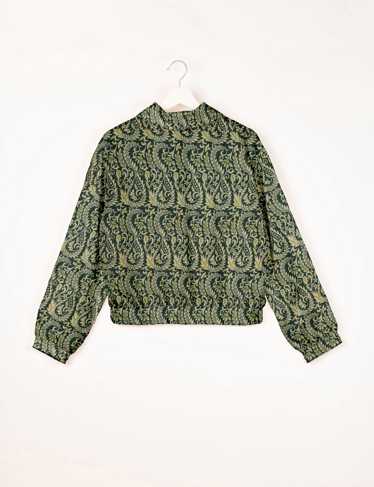 Green bomber jacket with intricate light green leaf and vine pattern, elastic cuffs and waistband, shown from back on hanger
