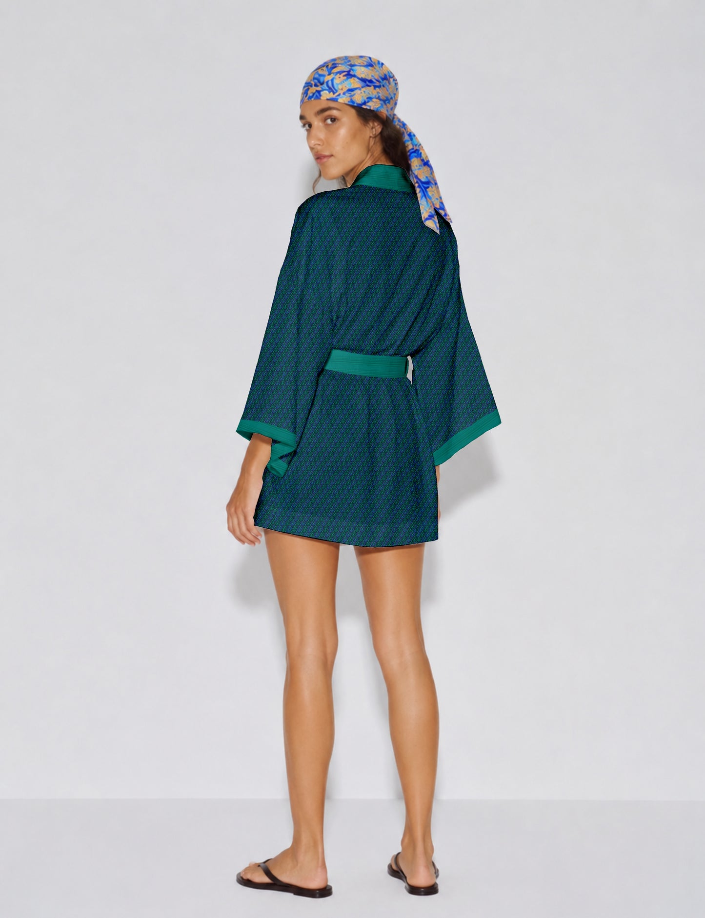 Short kimono robe with wrap front, V-neckline, wide sleeves, waist tie, and concealed skort detail.