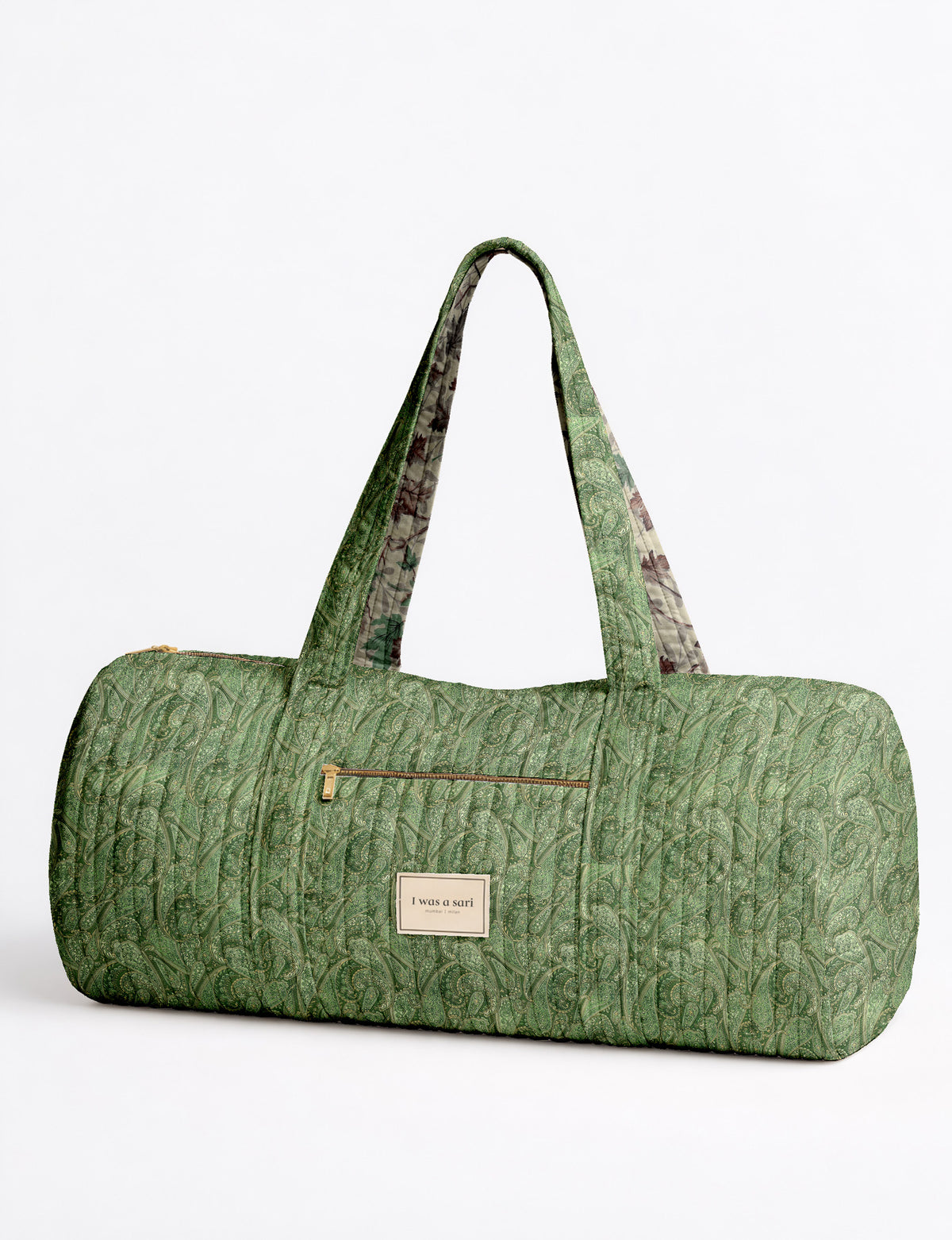 Brown paisley quilted bowling bag with dual handles, front zipper pocket, and "I was a sari" label on front side