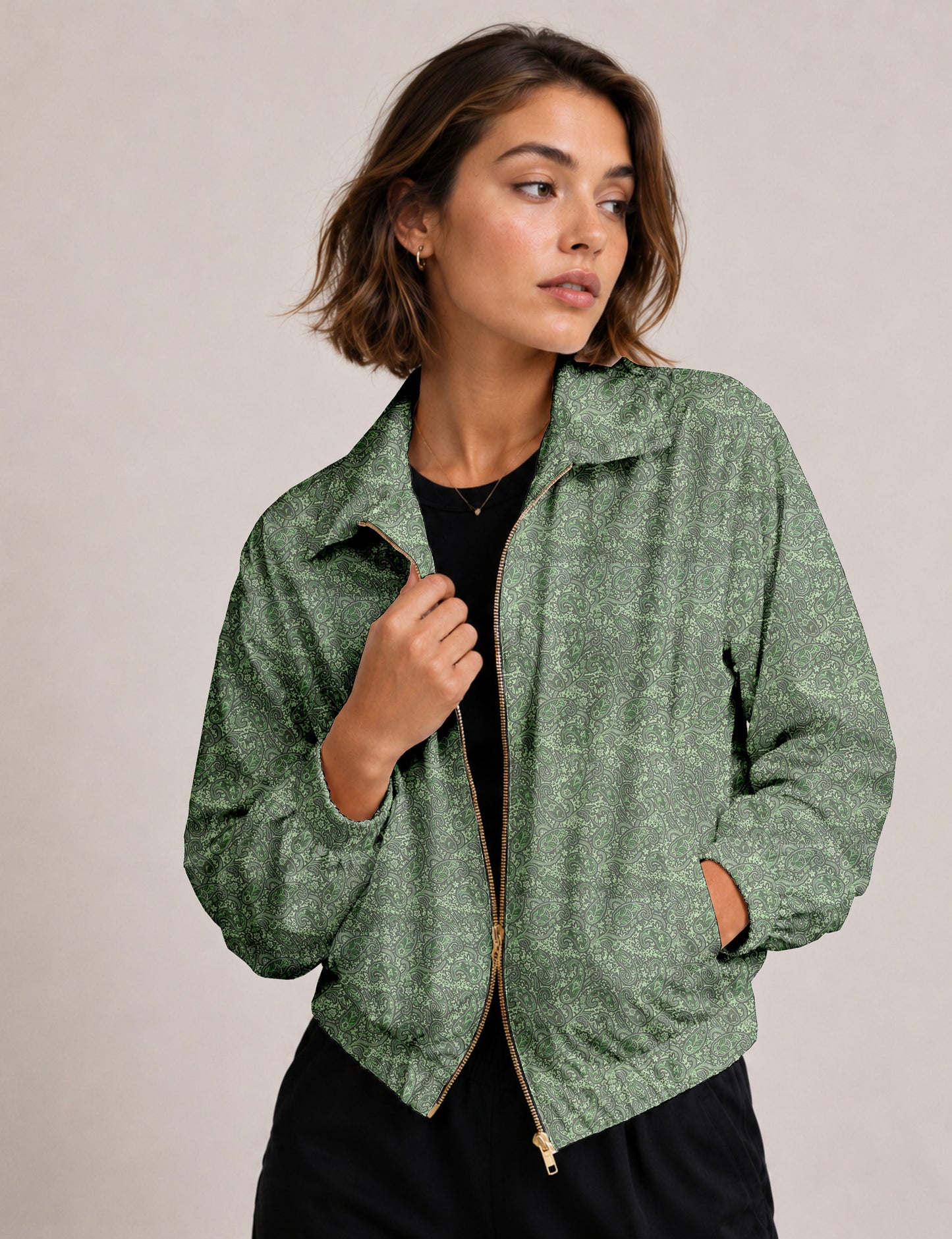 Woman wearing a yellow floral bomber jacket with front zipper, elastic cuffs, and side pockets, shown from front view