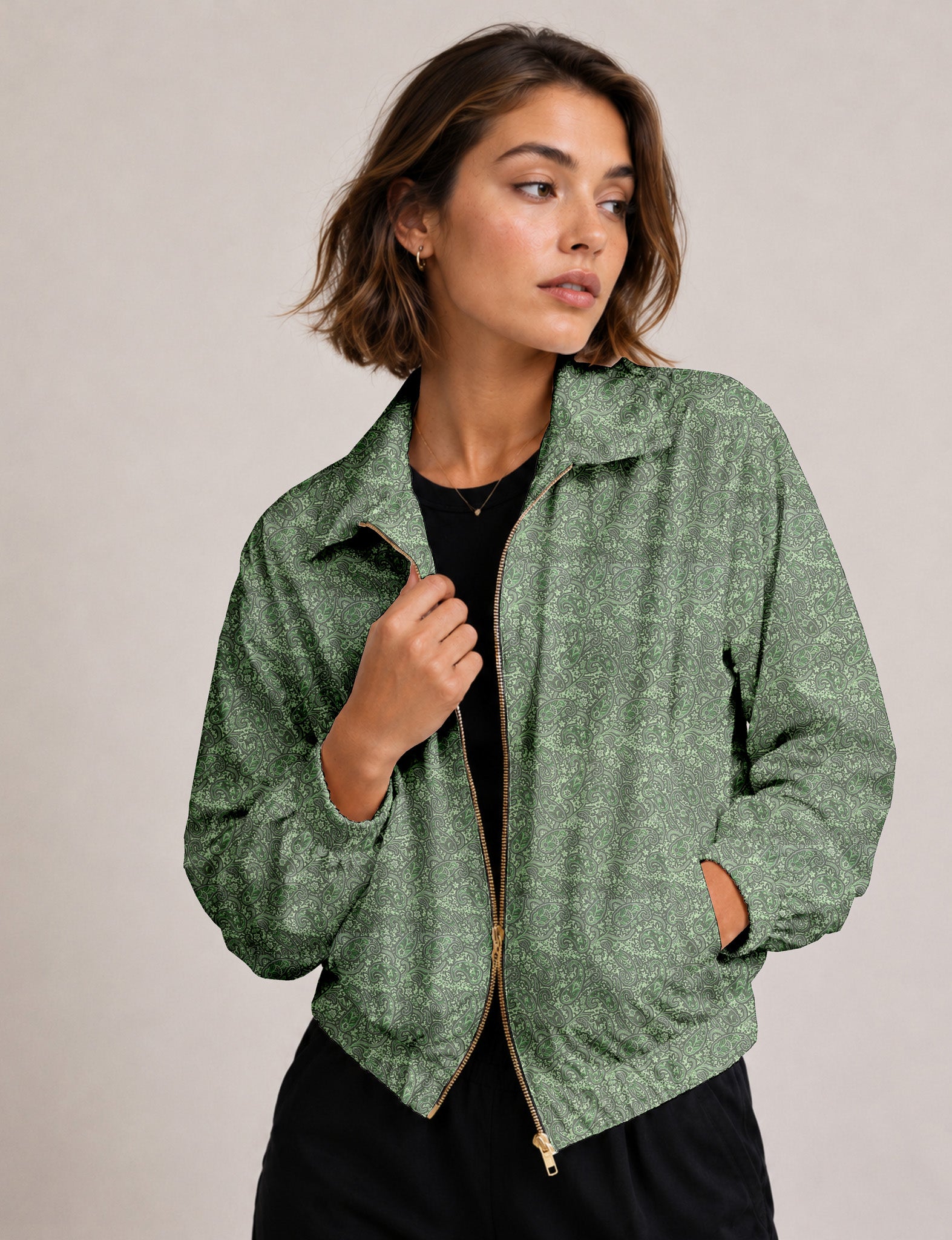Woman wearing a yellow floral bomber jacket with front zipper, elastic cuffs, and side pockets, shown from front view