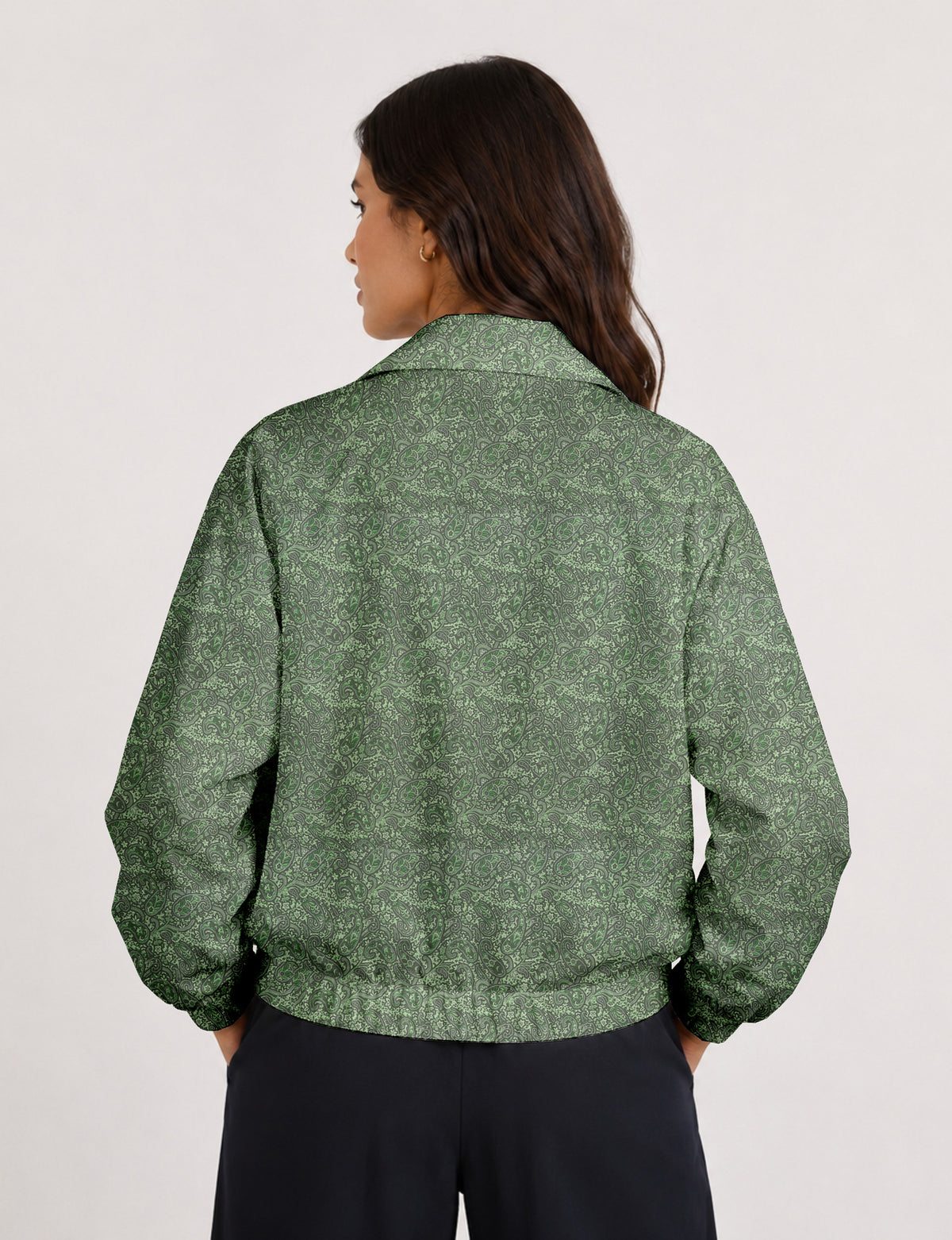 Brown floral bomber jacket with front zipper, elastic cuffs and hem, hanging on white hanger, red floral inner lining visible