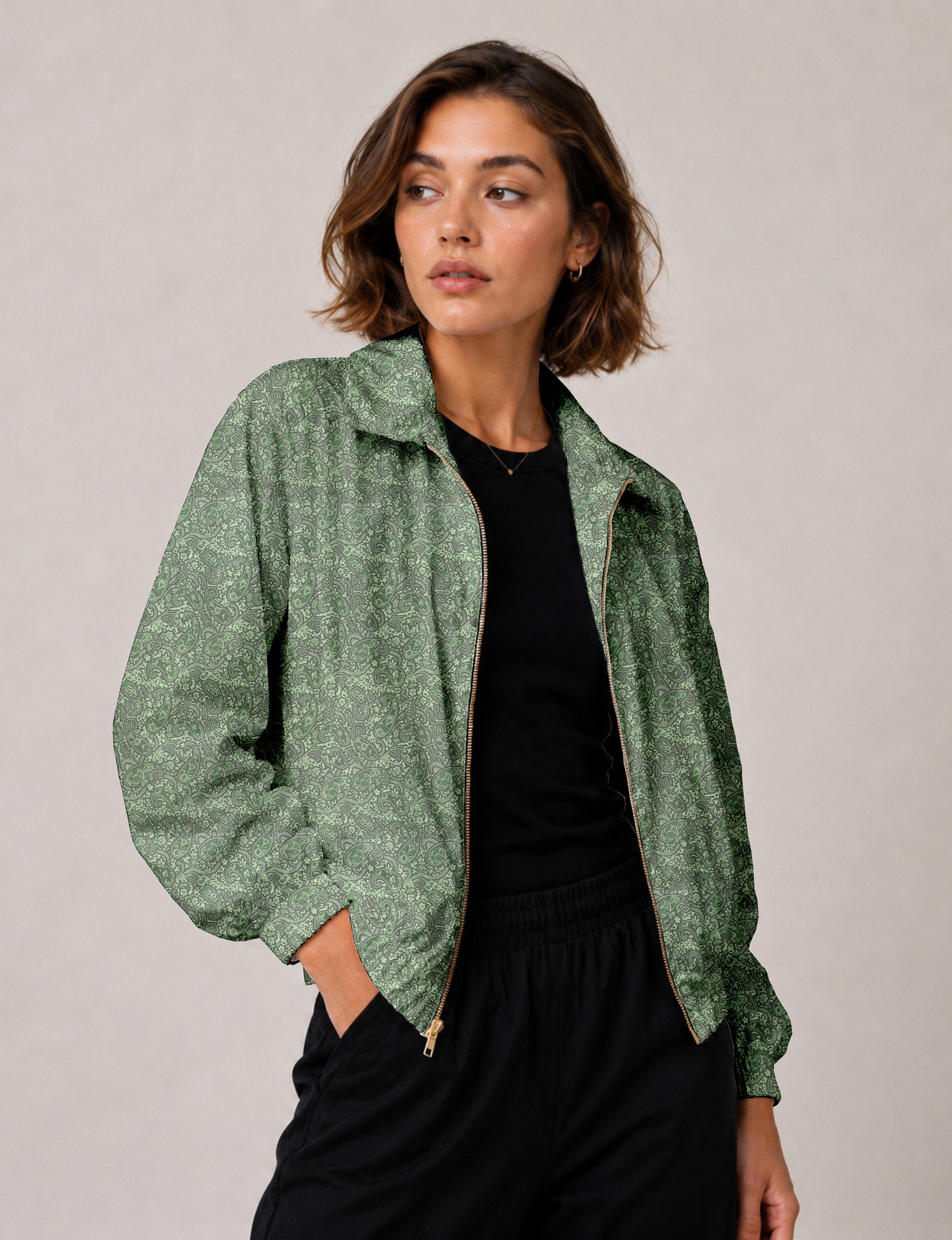 Woman wearing a yellow floral bomber jacket with front zipper, elastic cuffs, and side pockets, shown from front view