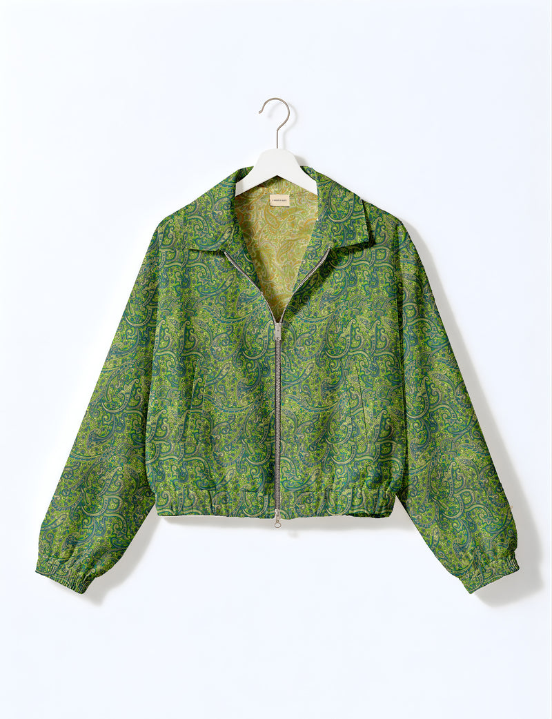 Woman wearing a yellow floral bomber jacket with front zipper, elastic cuffs, and side pockets, shown from front view