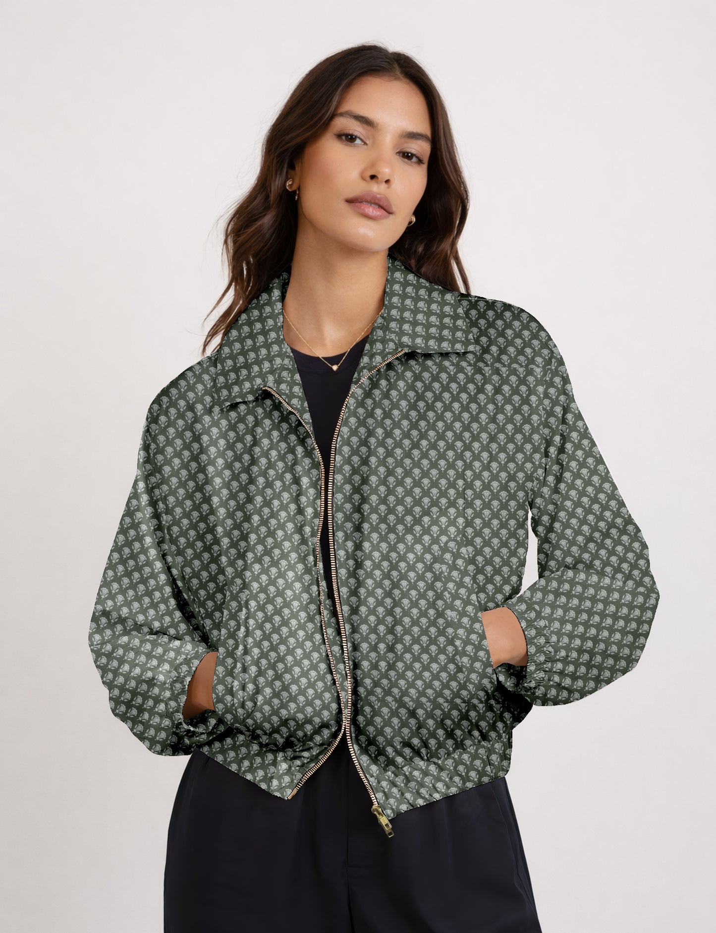 Women's cropped bomber jacket with twin metallic front zippers, welt pockets, elasticated hem and cuffs, and contrast sari print lining.