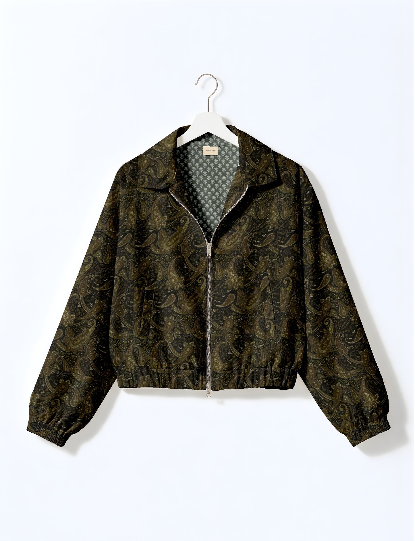 Women's cropped bomber jacket with twin metallic front zippers, welt pockets, elasticated hem and cuffs, and contrast sari print lining.
