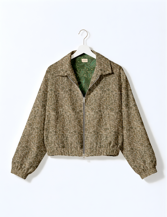 Women's cropped bomber jacket with twin metallic front zippers, welt pockets, elasticated hem and cuffs, and contrast sari print lining.