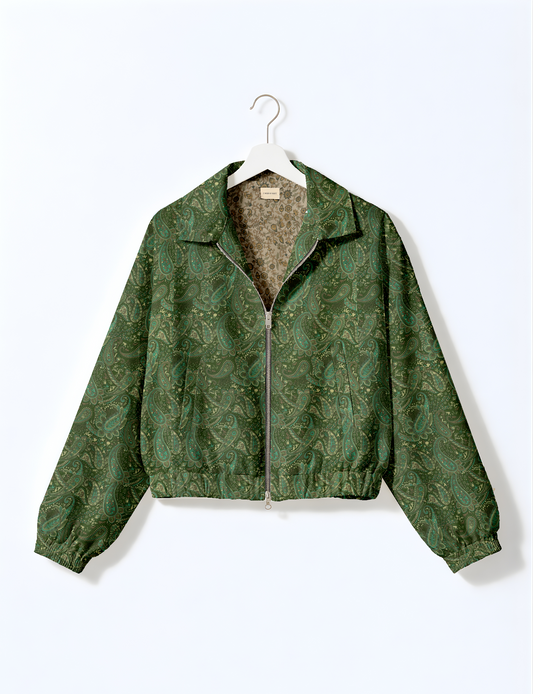 Women's cropped bomber jacket with twin metallic front zippers, welt pockets, elasticated hem and cuffs, and contrast sari print lining.