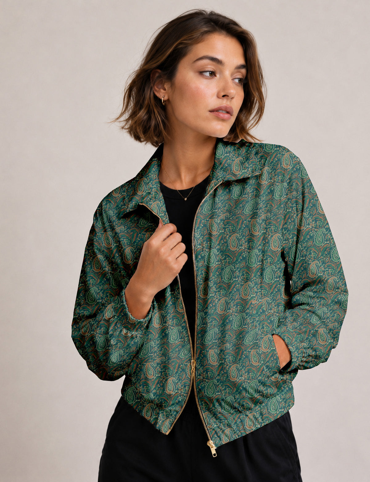 Woman wearing a yellow floral bomber jacket with front zipper, elastic cuffs, and side pockets, shown from front view