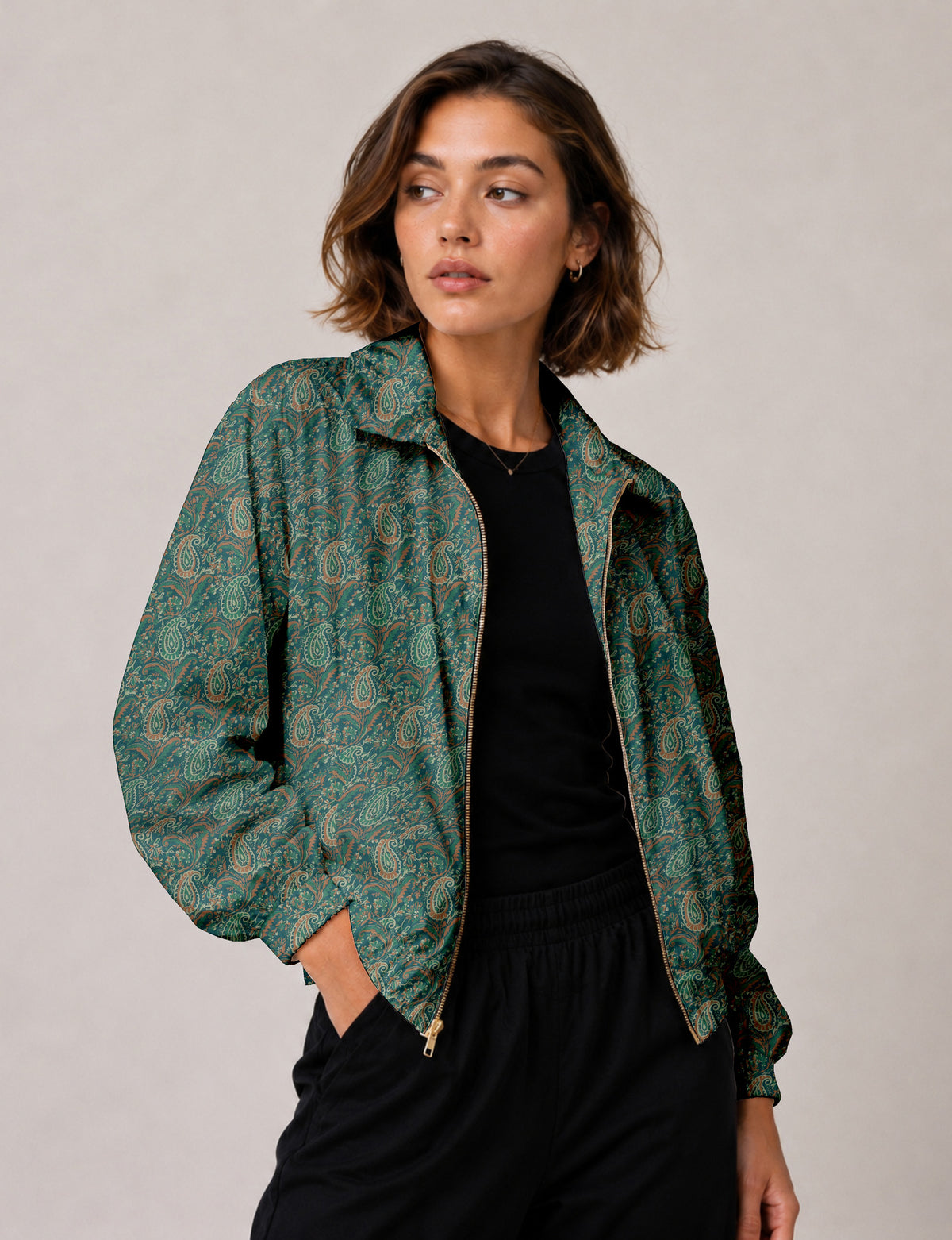 Brown floral bomber jacket with front zipper, elastic cuffs and hem, hanging on white hanger, red floral inner lining visible