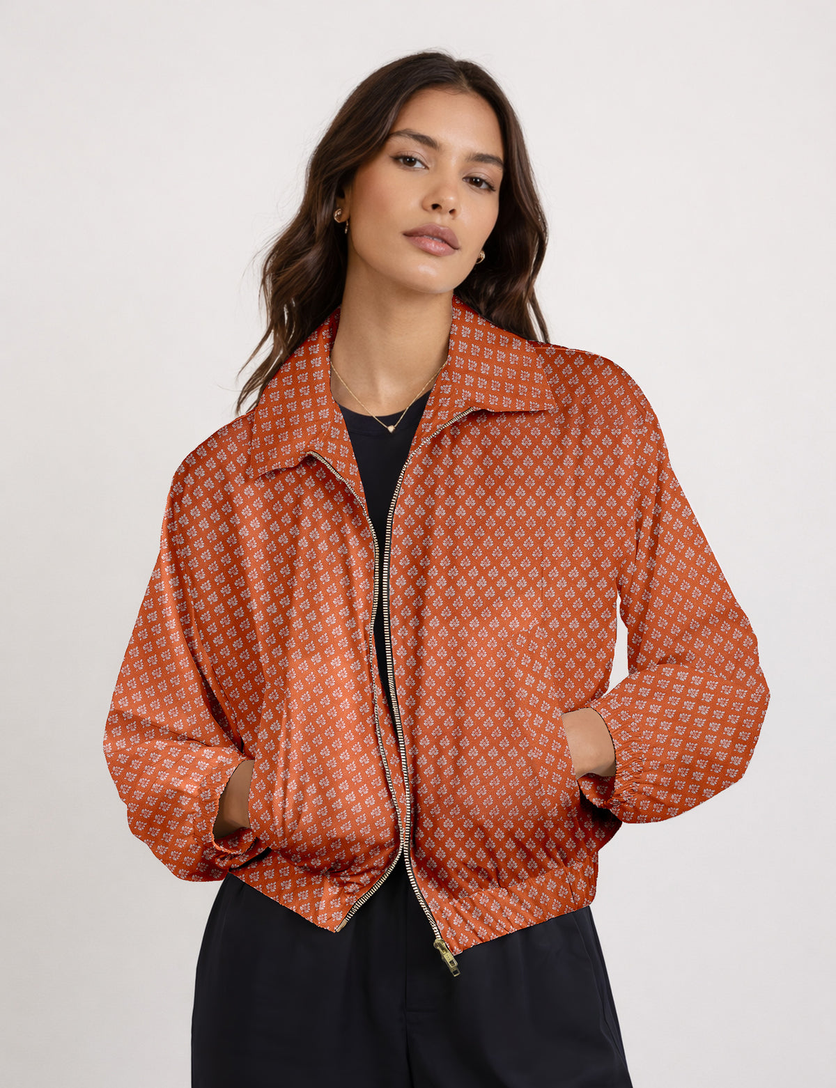 Woman wearing a yellow floral bomber jacket with front zipper, elastic cuffs, and side pockets, shown from front view