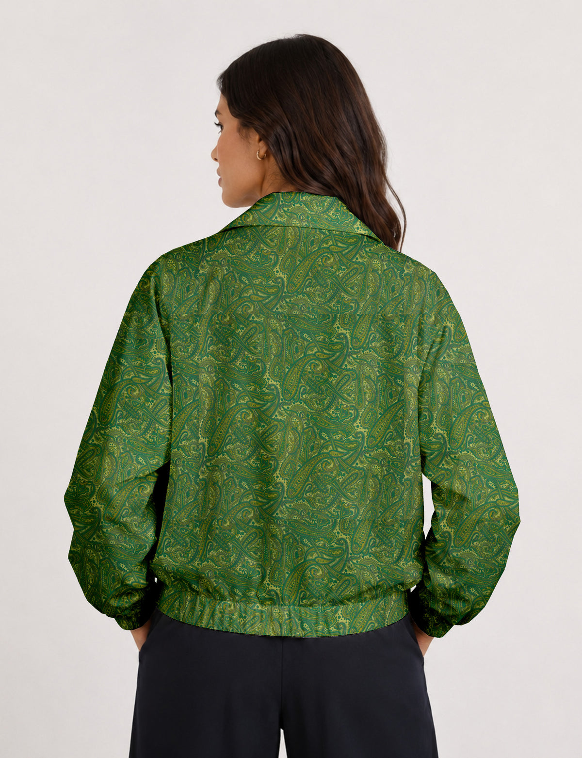 Woman wearing a yellow floral bomber jacket with front zipper, elastic cuffs, and side pockets, shown from front view