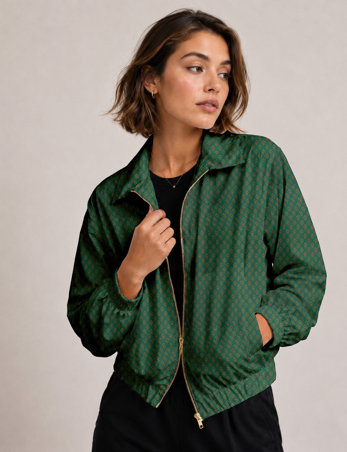 Brown floral bomber jacket with front zipper, elastic cuffs and hem, hanging on white hanger, red floral inner lining visible