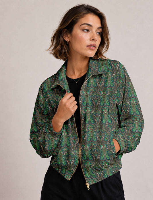 Woman wearing a yellow floral bomber jacket with front zipper, elastic cuffs, and side pockets, shown from front view