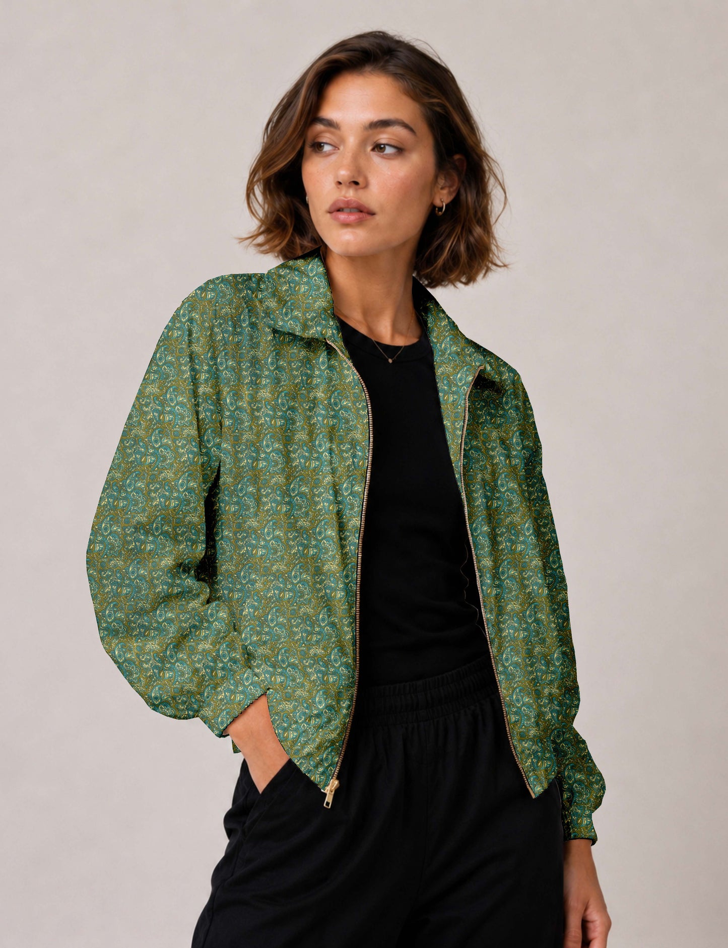 Woman wearing a yellow floral bomber jacket with front zipper, elastic cuffs, and side pockets, shown from front view