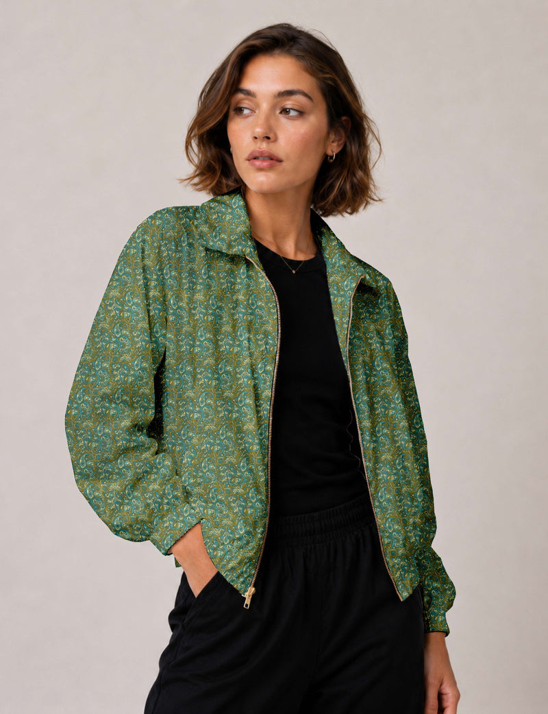 Woman wearing a yellow floral bomber jacket with front zipper, elastic cuffs, and side pockets, shown from front view