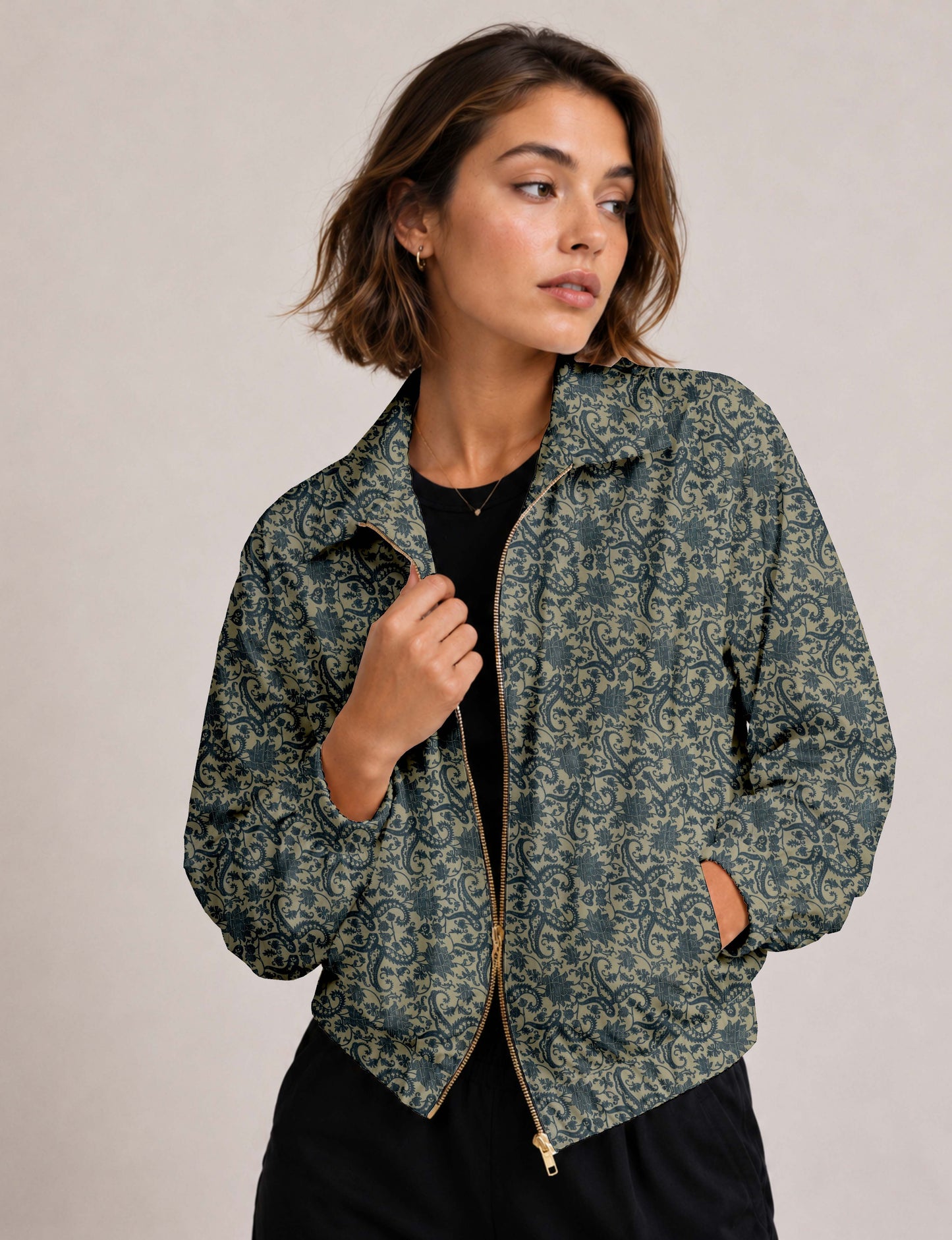 Brown floral bomber jacket with front zipper, elastic cuffs and hem, hanging on white hanger, red floral inner lining visible
