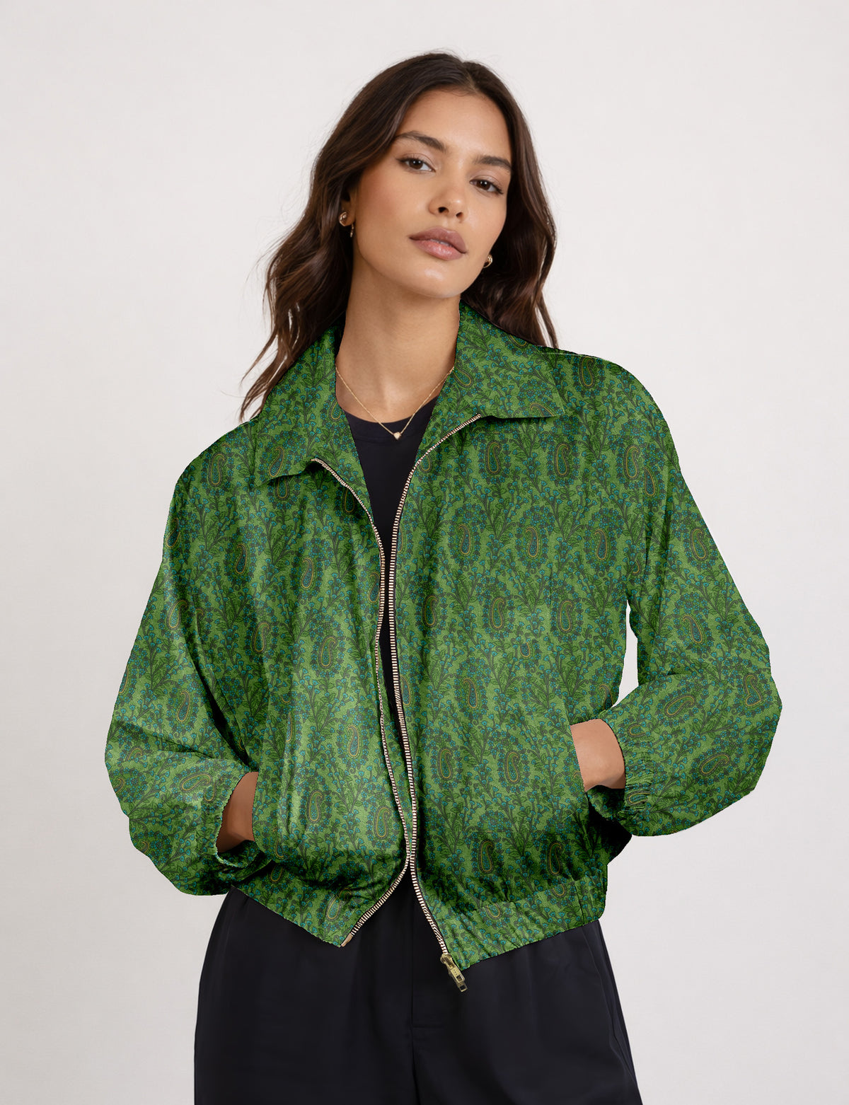Brown floral bomber jacket with front zipper, elastic cuffs and hem, hanging on white hanger, red floral inner lining visible
