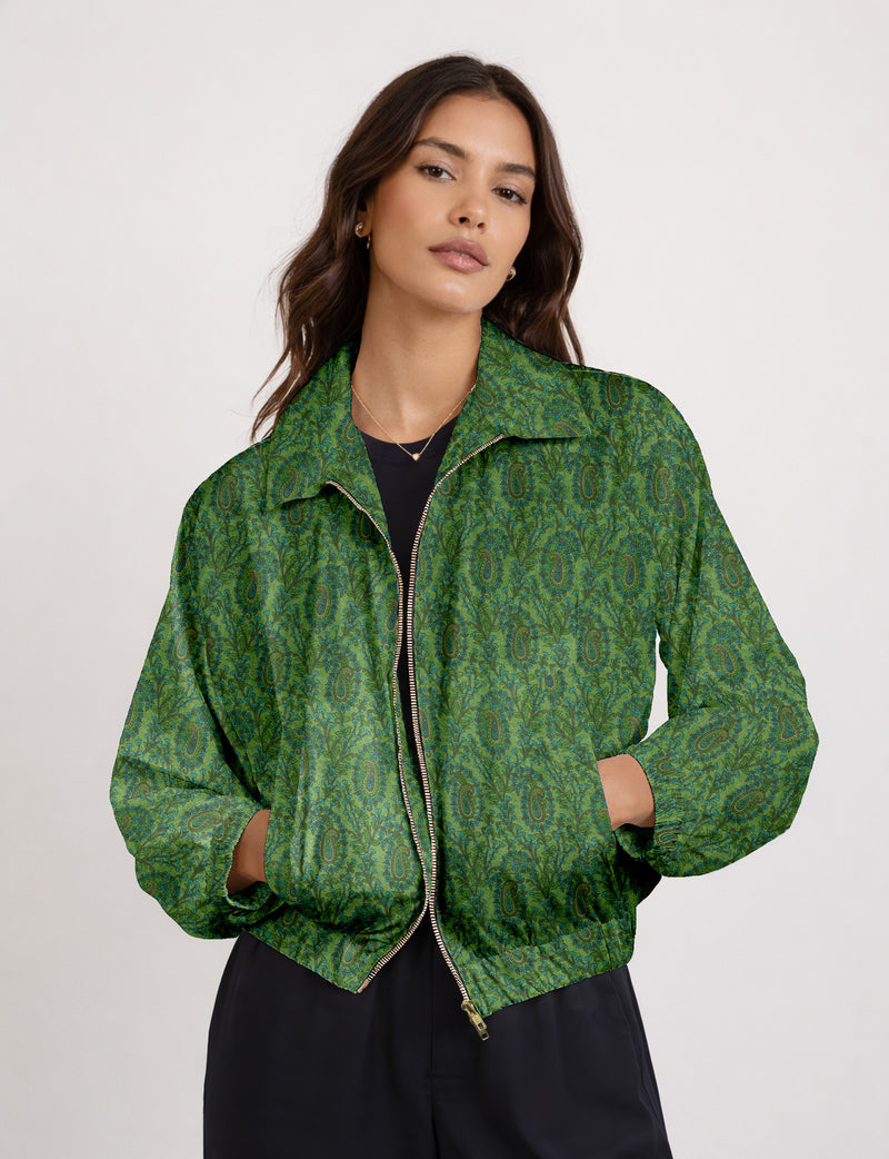 Brown floral bomber jacket with front zipper, elastic cuffs and hem, hanging on white hanger, red floral inner lining visible