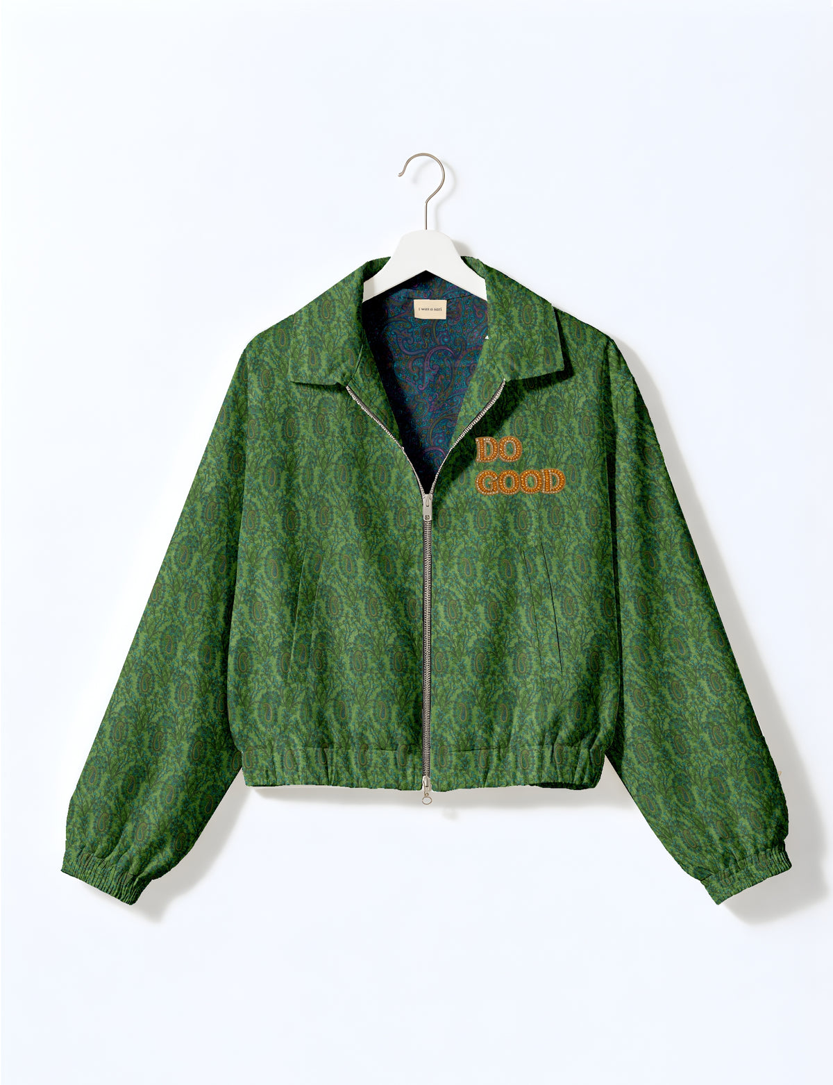 Gold cropped DO GOOD bomber jacket featuring hand-embroidered lettering on the left chest, contrasting inner lining and two functional pockets.
