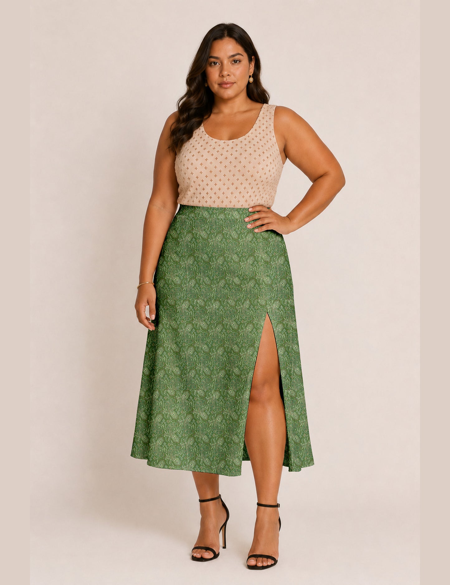 Woman wearing a yellow and black micro patterned A-line skirt with front slit, paired with beige sleeveless top and black