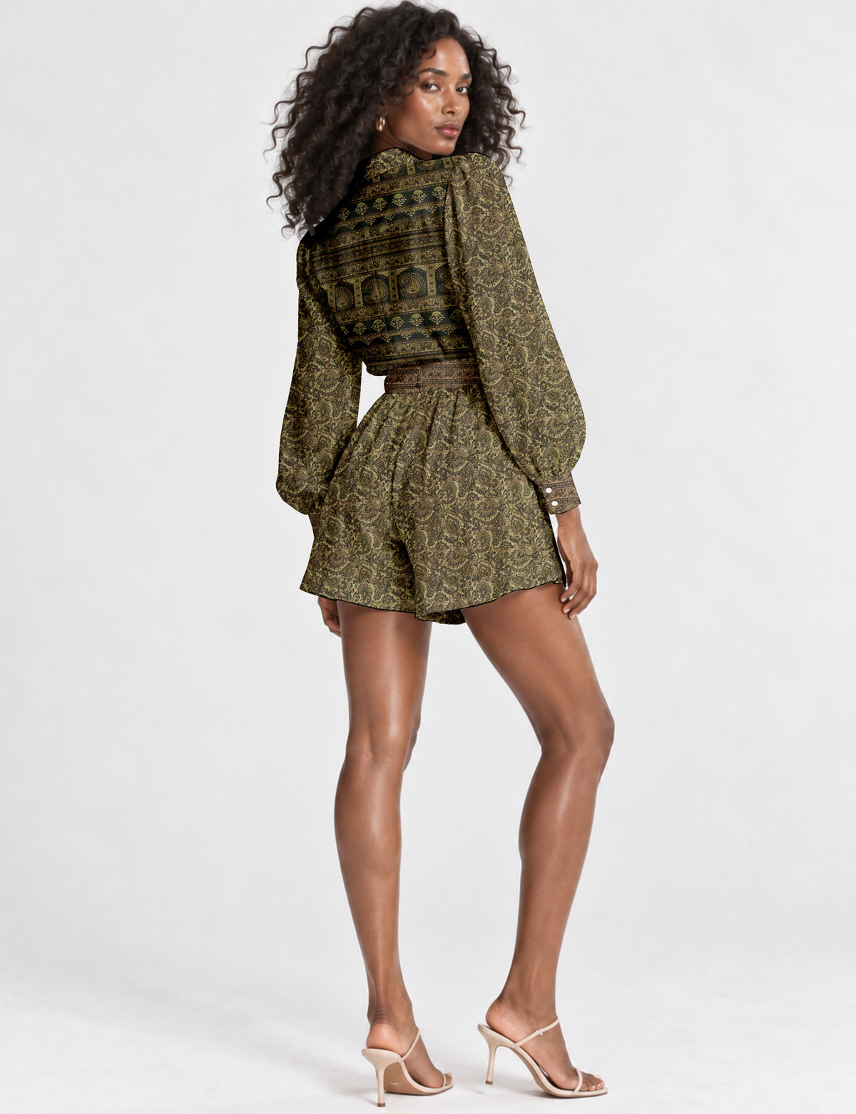 Women’s long sleeve playsuit with wrap-style front, V neckline, notched collar, adjustable waist tie and mid-thigh shorts.
