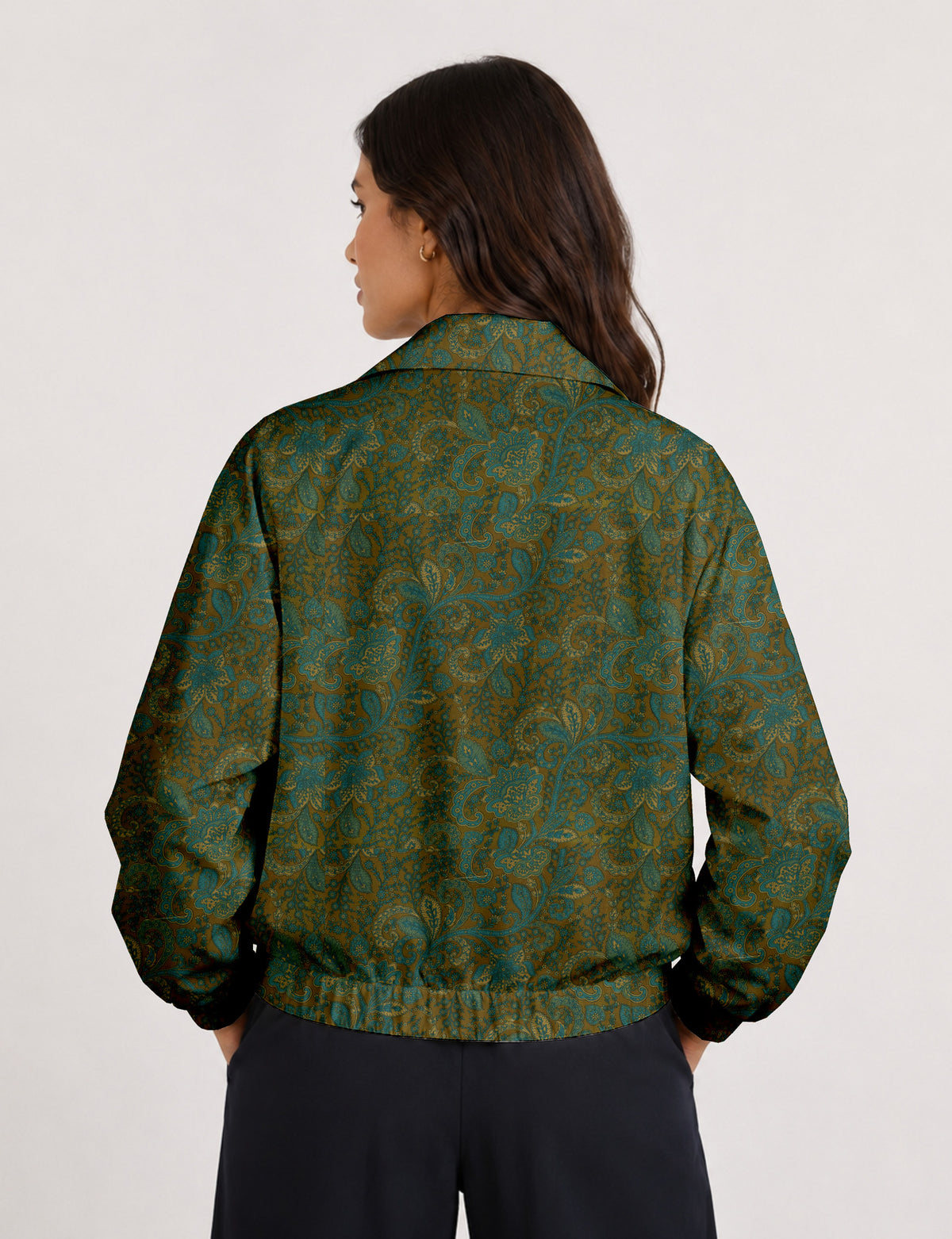 Woman wearing a yellow floral bomber jacket with front zipper, elastic cuffs, and side pockets, shown from front view
