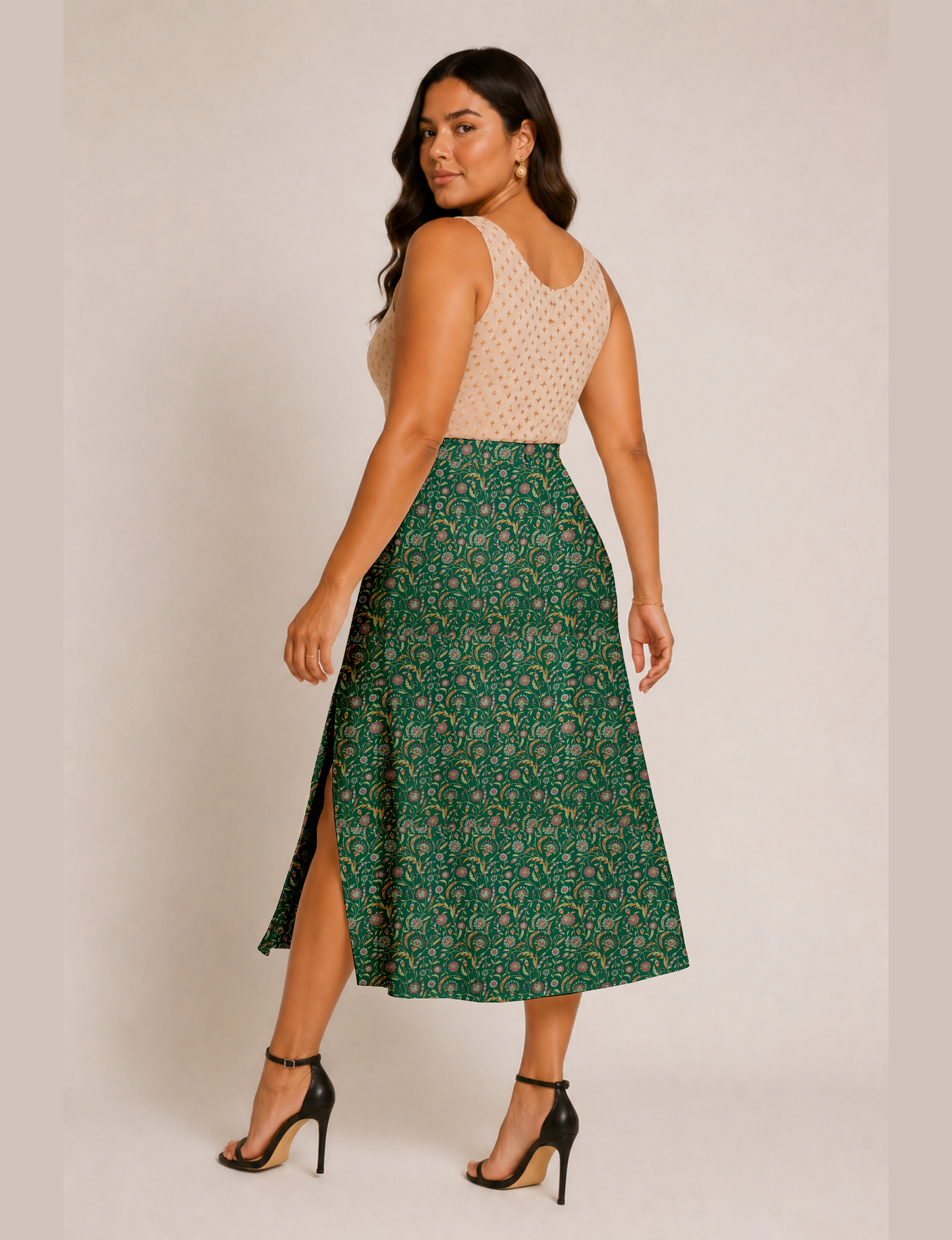 Woman wearing a yellow and black micro patterned A-line skirt with front slit, paired with beige sleeveless top and black