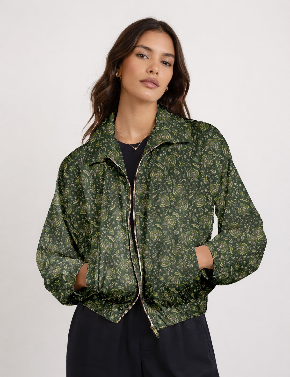Woman wearing a yellow floral bomber jacket with front zipper, elastic cuffs, and side pockets, shown from front view